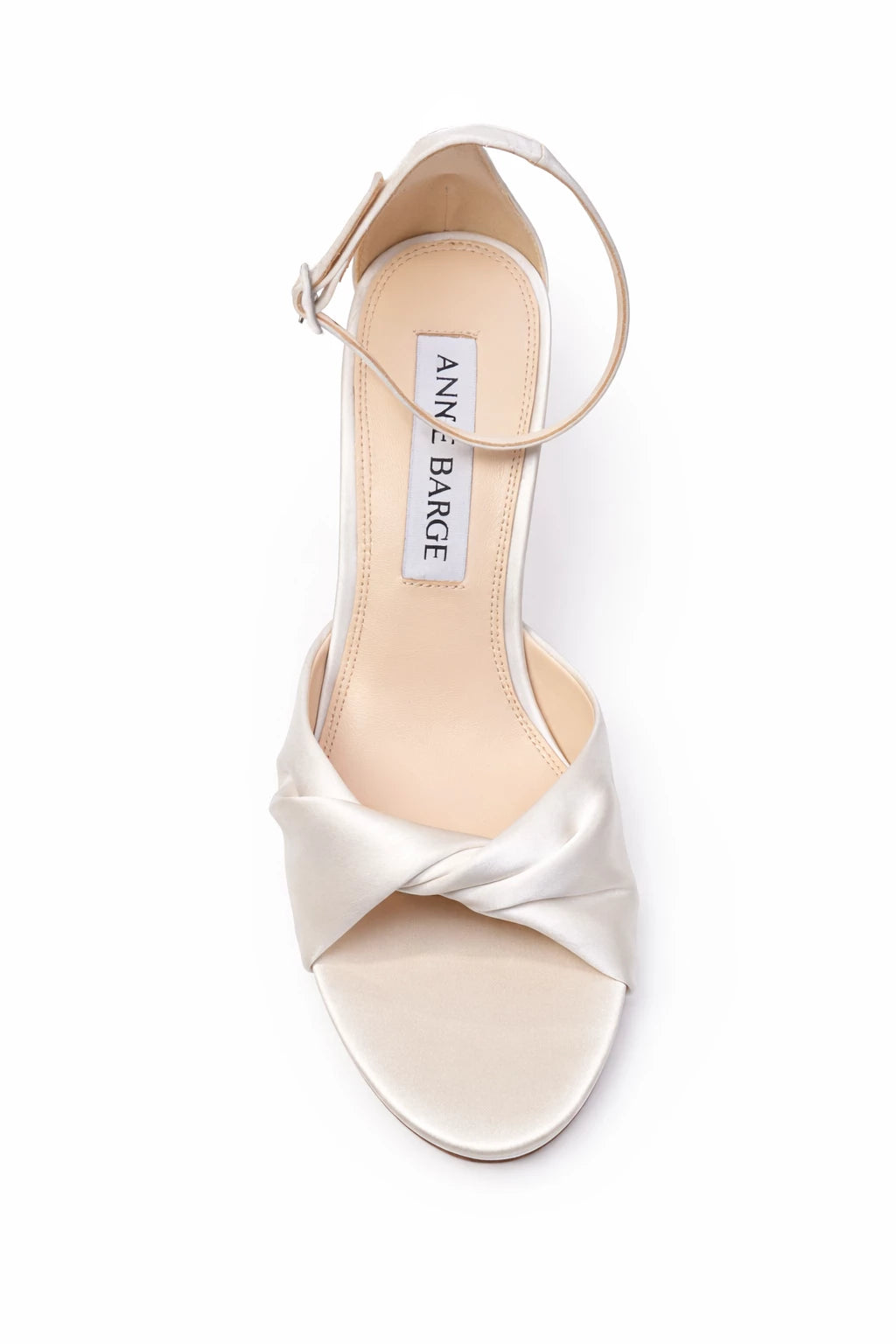 The Anne Barge Amour wedding shoe, is a round toe micro platform sandal in White Satin with a twisted upper pleat detailing, set on a 100 mm micro platform and stiletto heel.