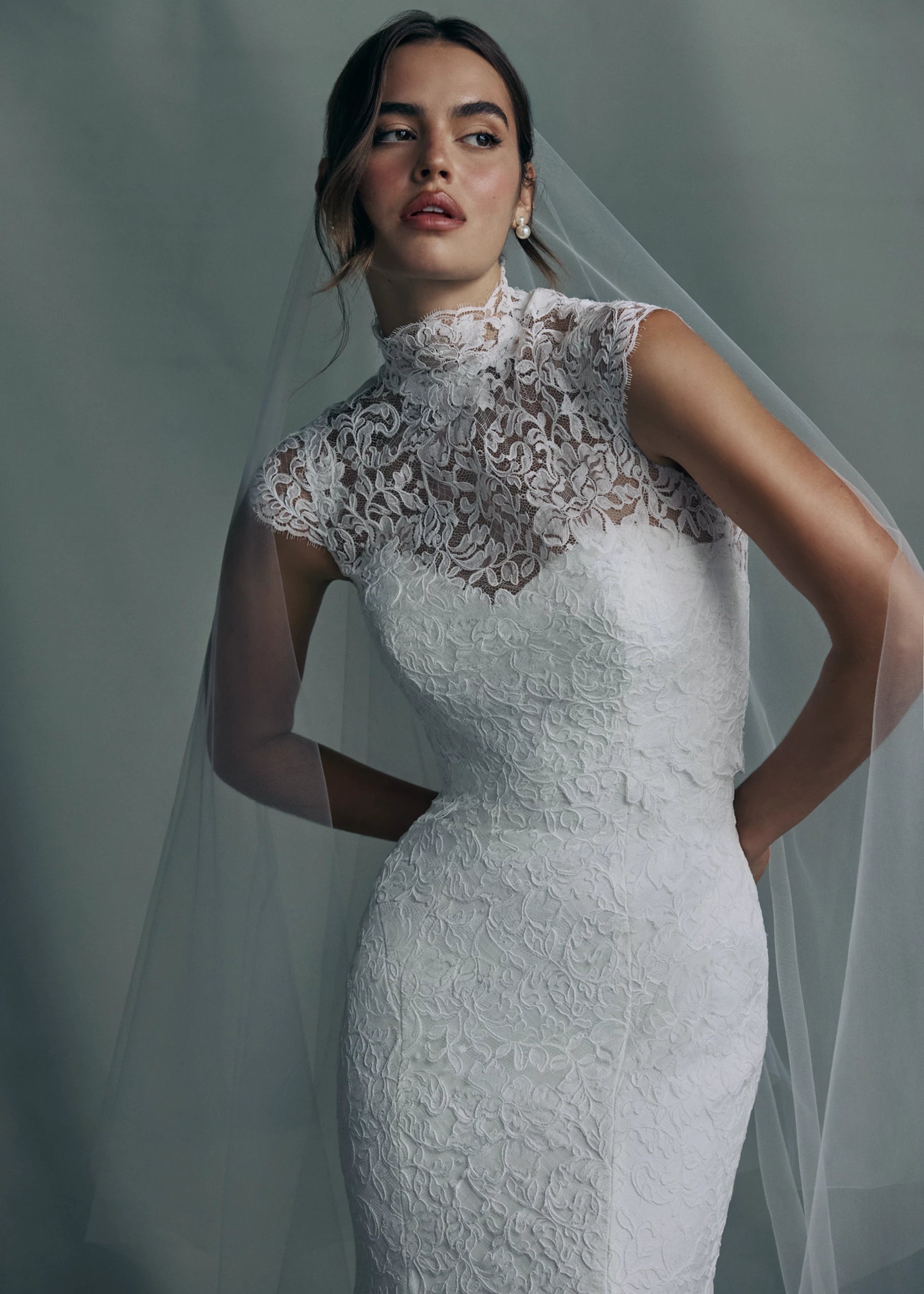 The Anouk gown paired with the Anouk Top, a mockneck cap sleeve topper of Corded Scrolling Floral Lace.