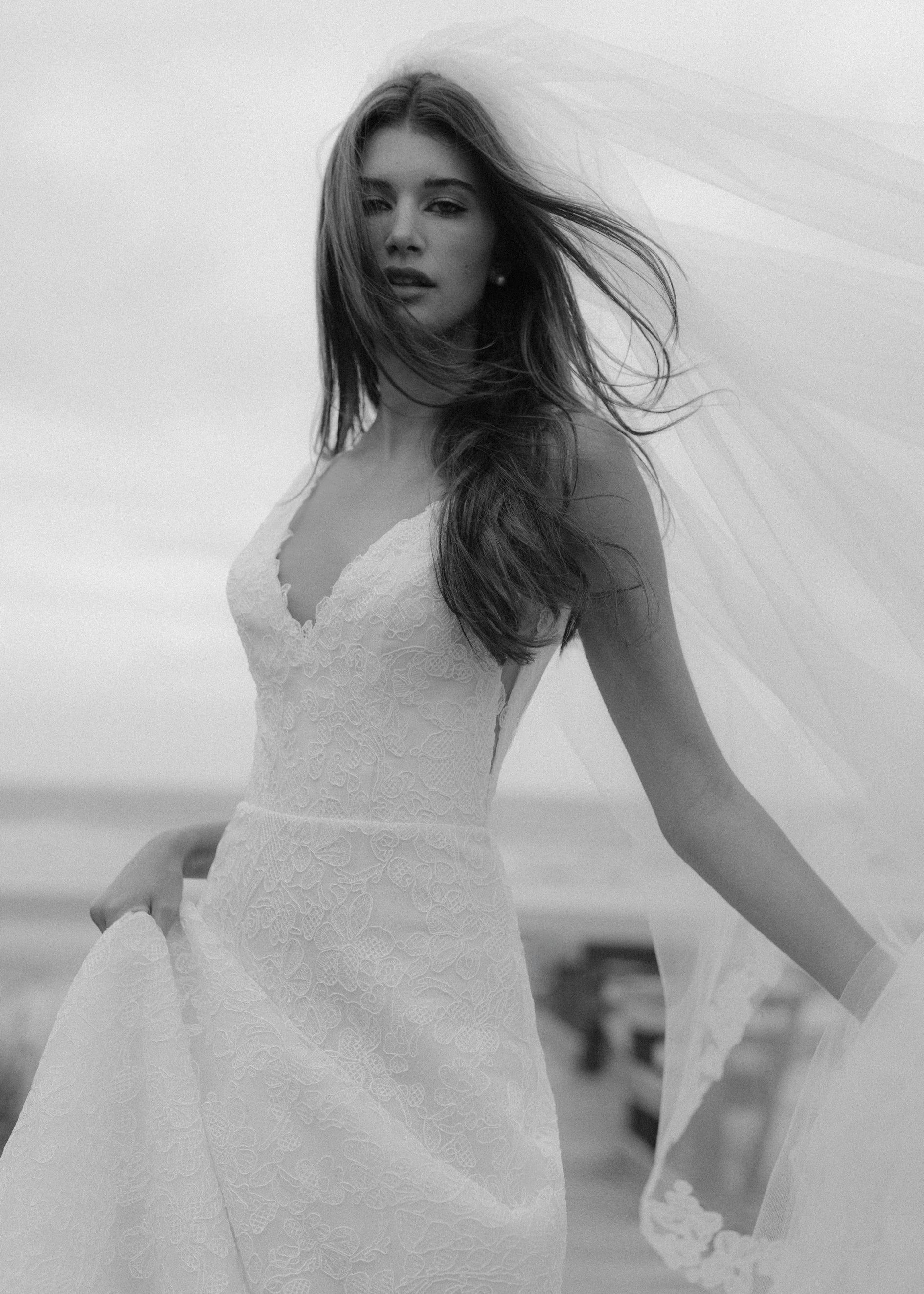 The Ashley gown is a V-neck gown of Scrollwork Embroidery with soft A-line skirt in Pearl.