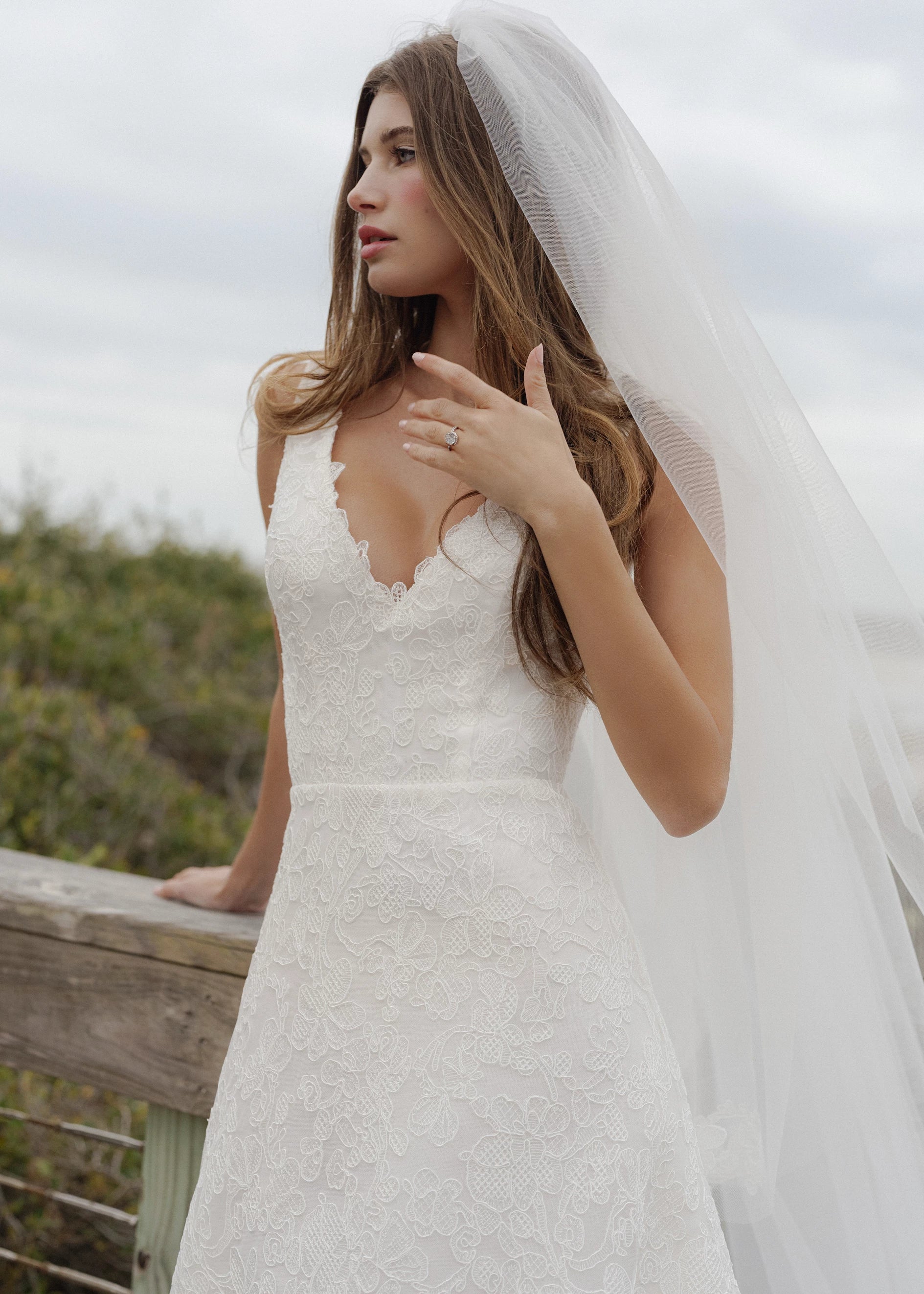 The Ashley gown is a V-neck gown of Scrollwork Embroidery with soft A-line skirt in Pearl.
