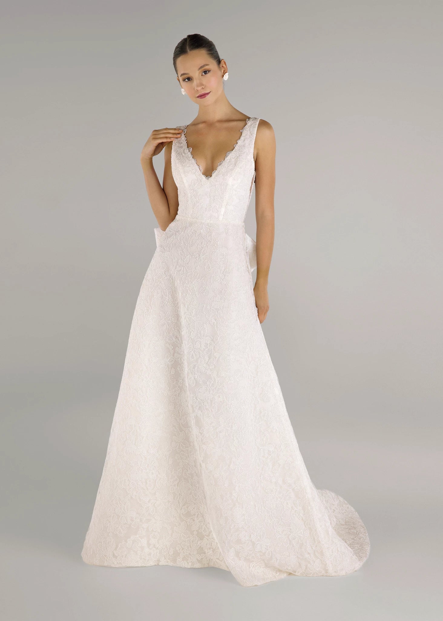 The Ashley gown is a V-neck gown of Scrollwork Embroidery with soft A-line skirt in Pearl.
