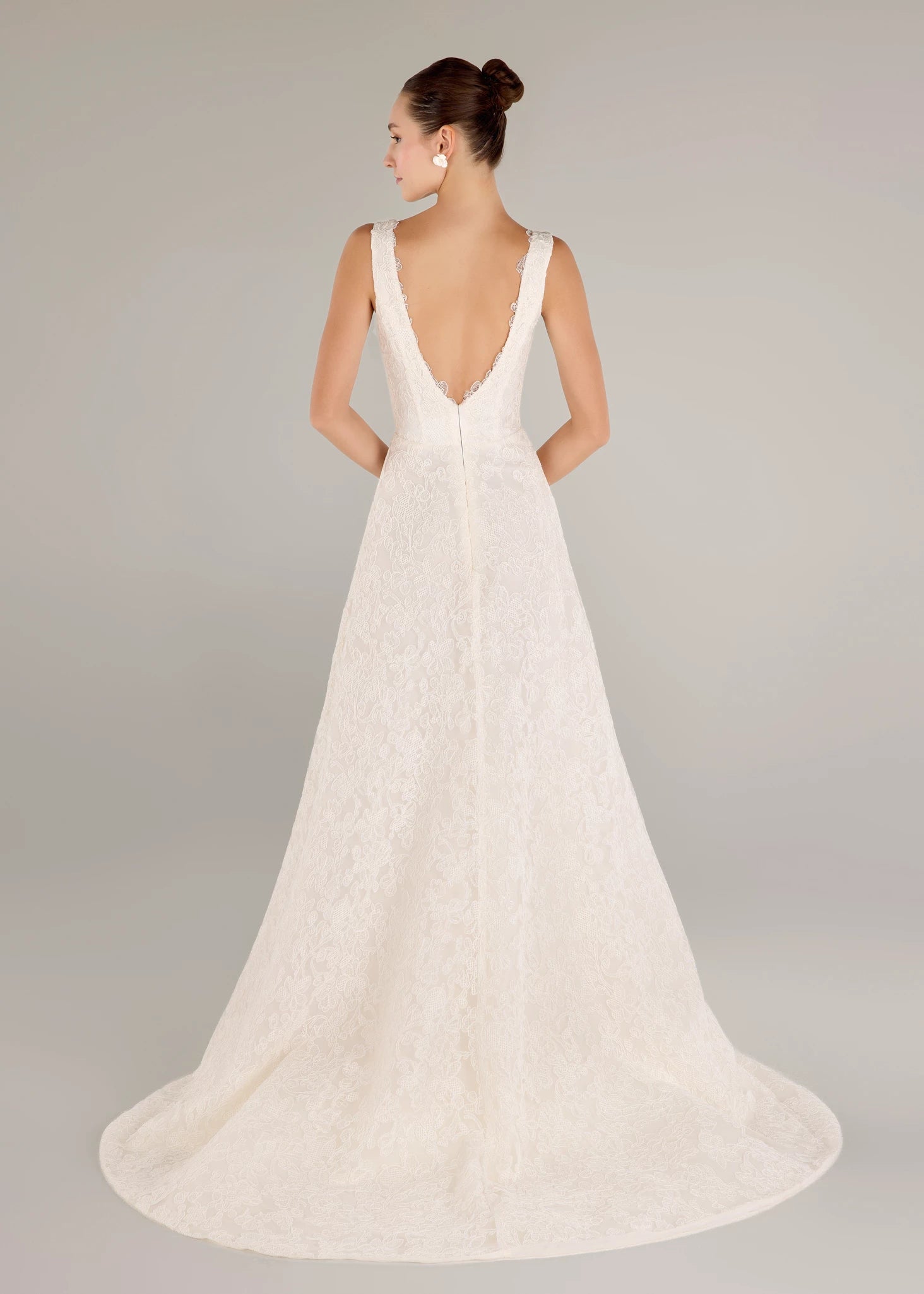 The Ashley gown is a V-neck gown of Scrollwork Embroidery with soft A-line skirt in Pearl.