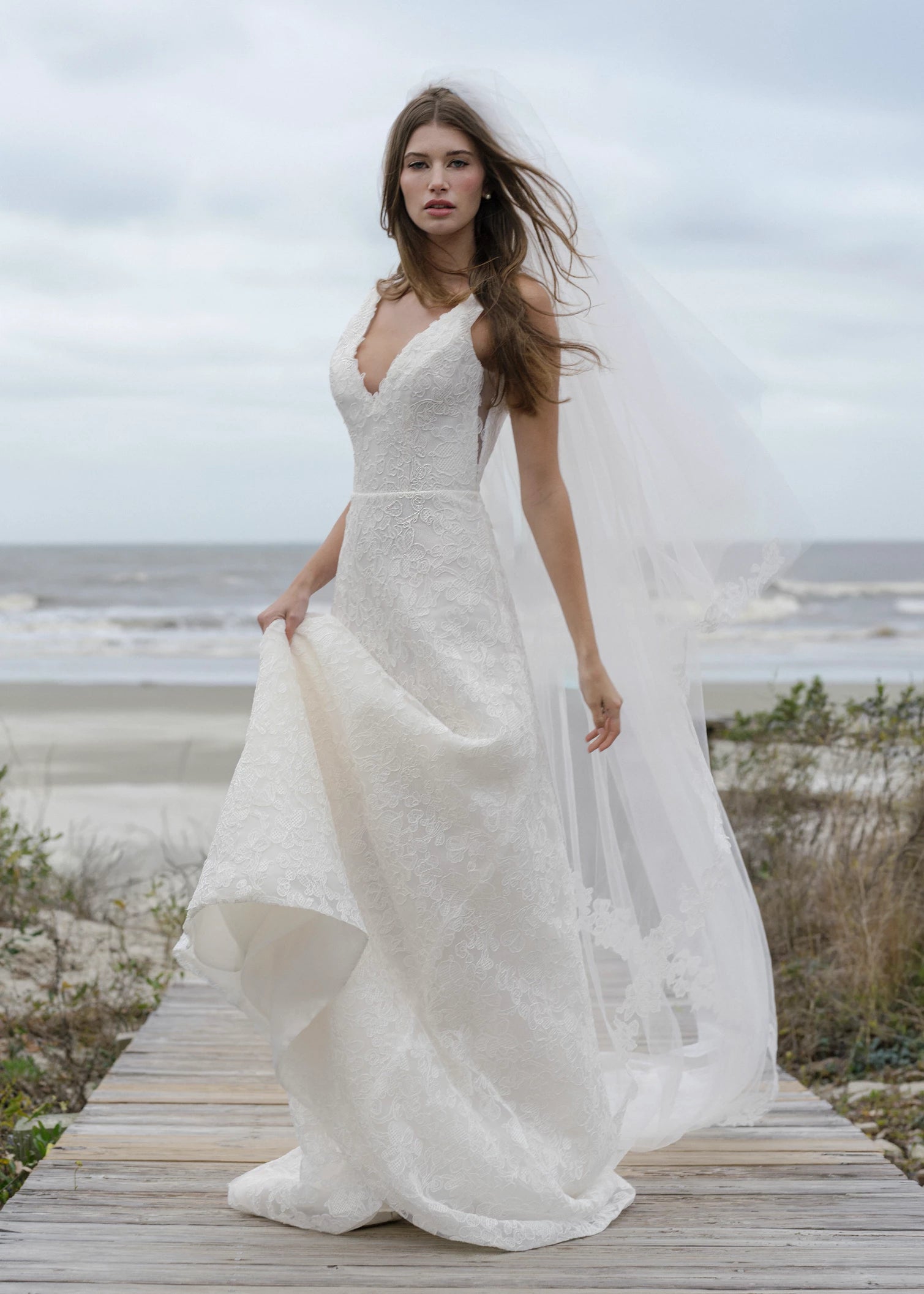 The Ashley gown is a V-neck gown of Scrollwork Embroidery with soft A-line skirt in Pearl.