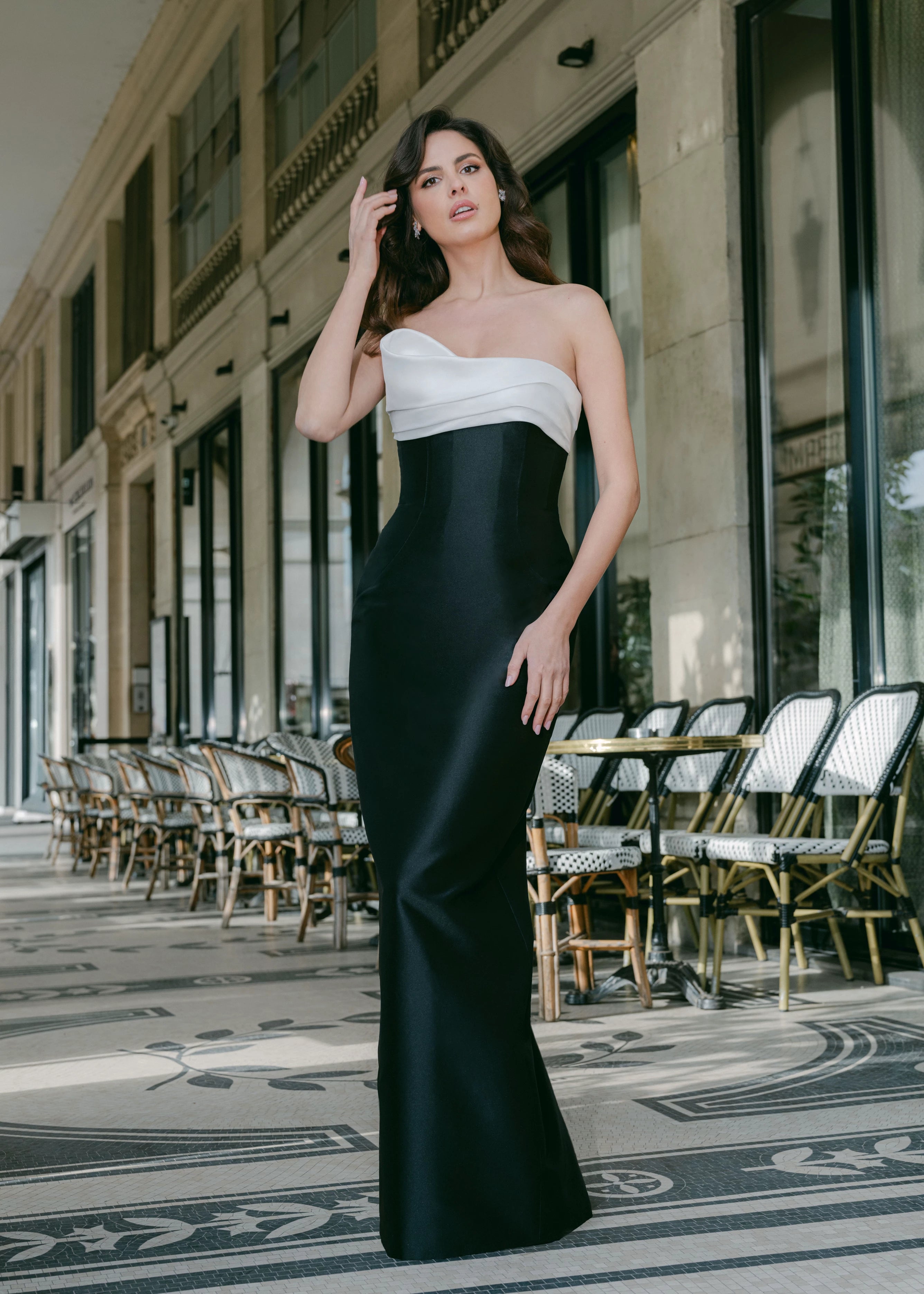 The Coco evening gown from Black Label by Anne Barge is a straight column gown of contrasting Mikado with asymmetrically draped bodice cuff.