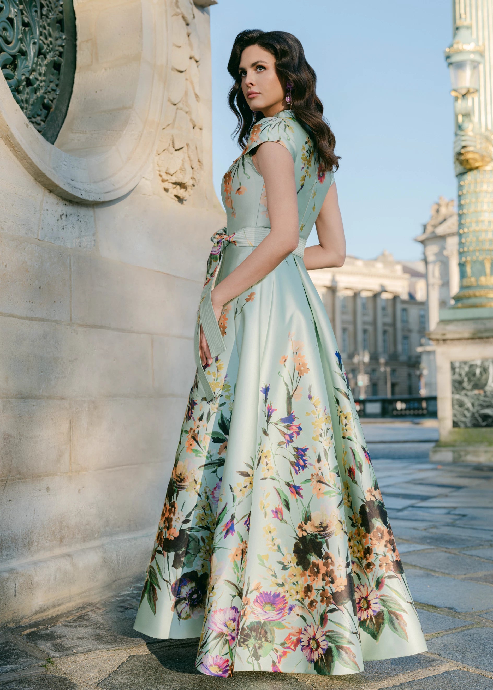 The Honfleur Watercolor evening gown from Black Label by Anne Barge is a cap sleeve V-notch A-line gown of Watercolor Meadow Printed Mikado in Pistachio.