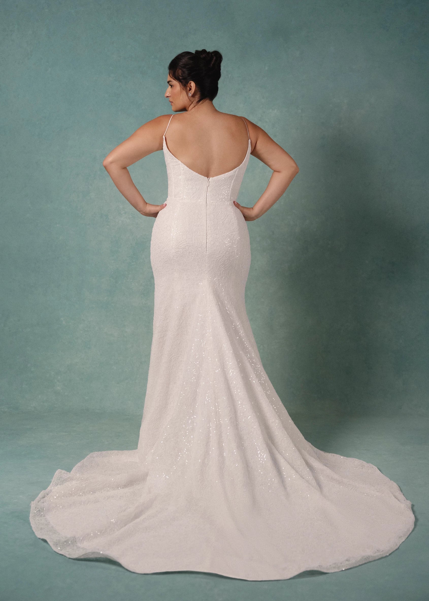 The Delia is a Spaghetti strap contour neckline gown with molded corset and softly flared skirt, in Sequined Corded Embroidery over Chantilly lace.
