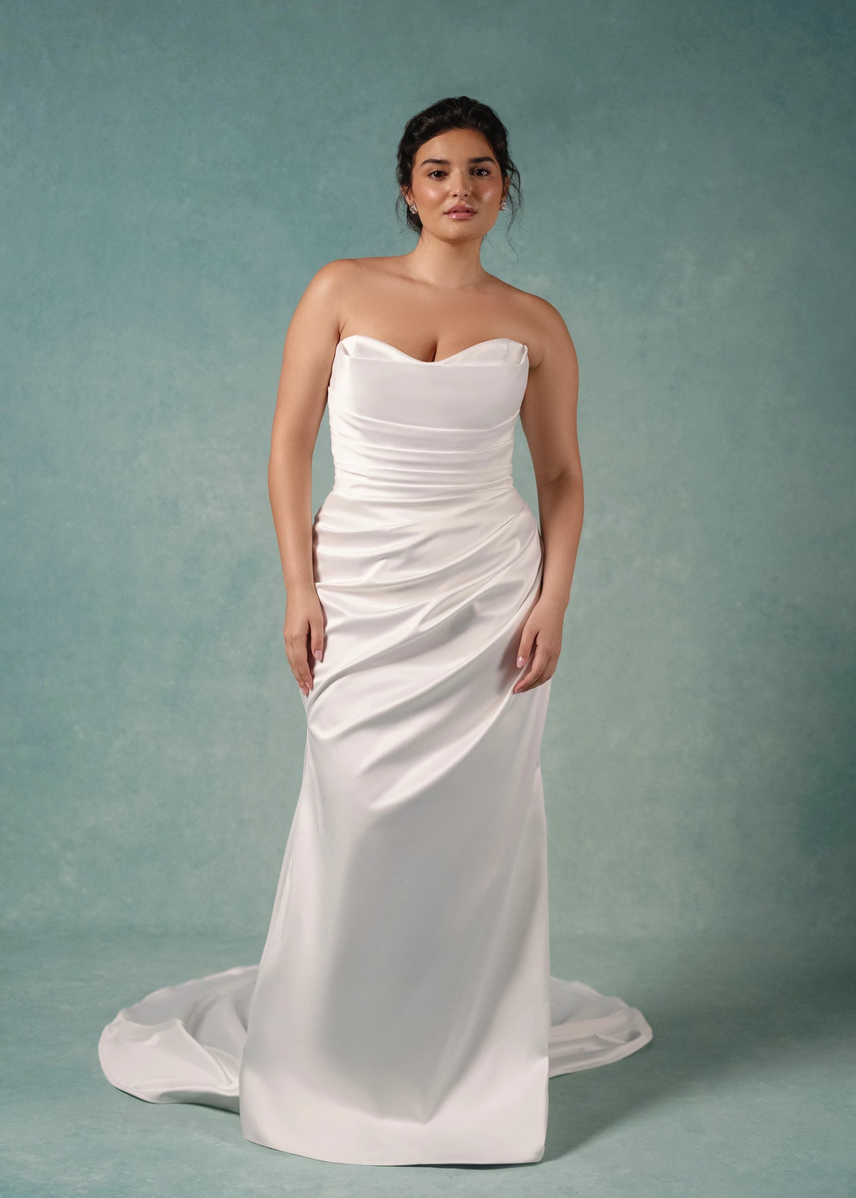 The Marielle gown is a dramatically draped column gown of Crepe-Back Satin featuring a peek-a-boo sweetheart neckline with Petal Beaded Embroidery and buttons to the hem