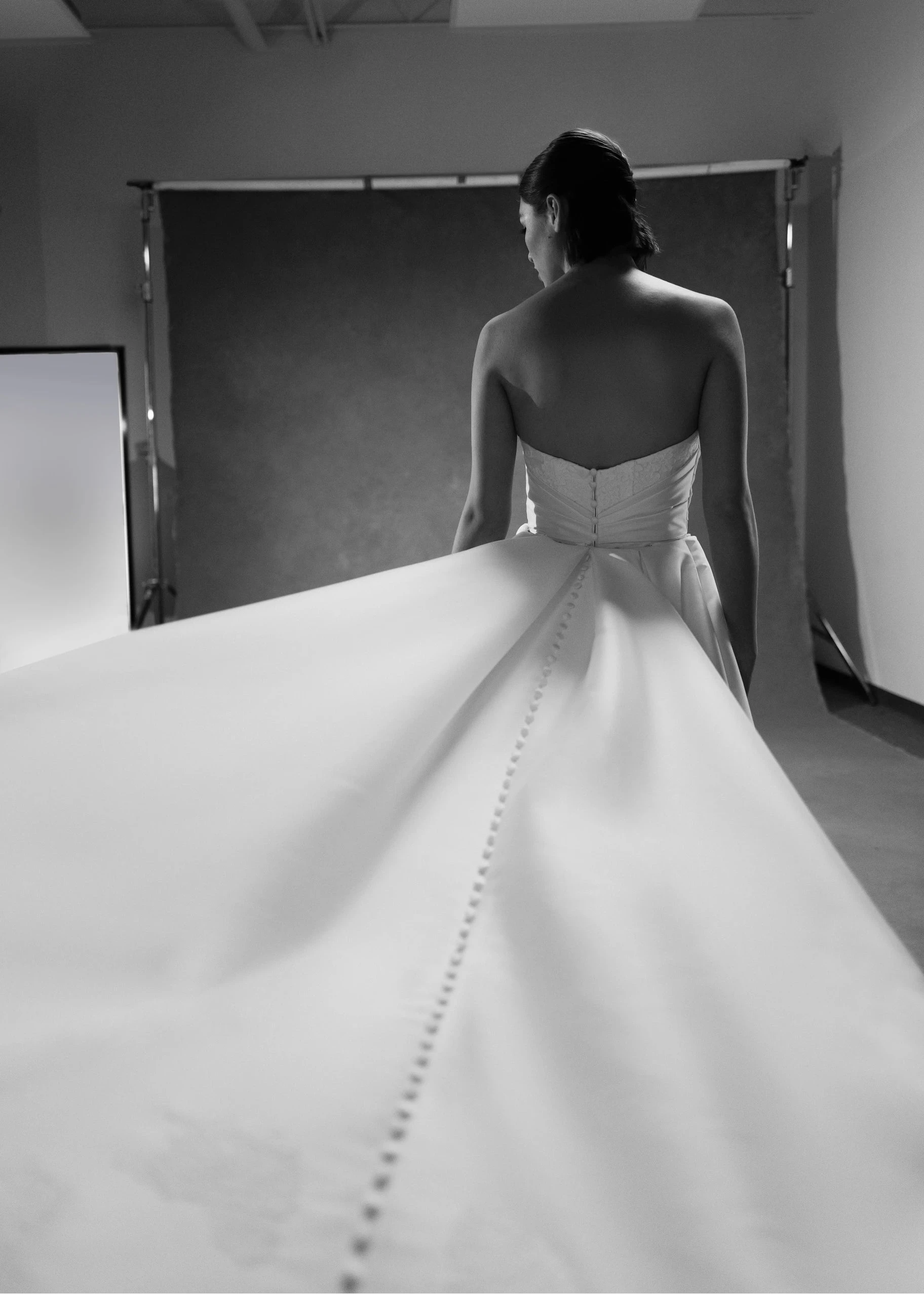 The Blue Willow Kaia Train is a dramatic detachable train of Soft Mikado, accented with a Corded Lace scalloped hem and buttons in Pearl.
