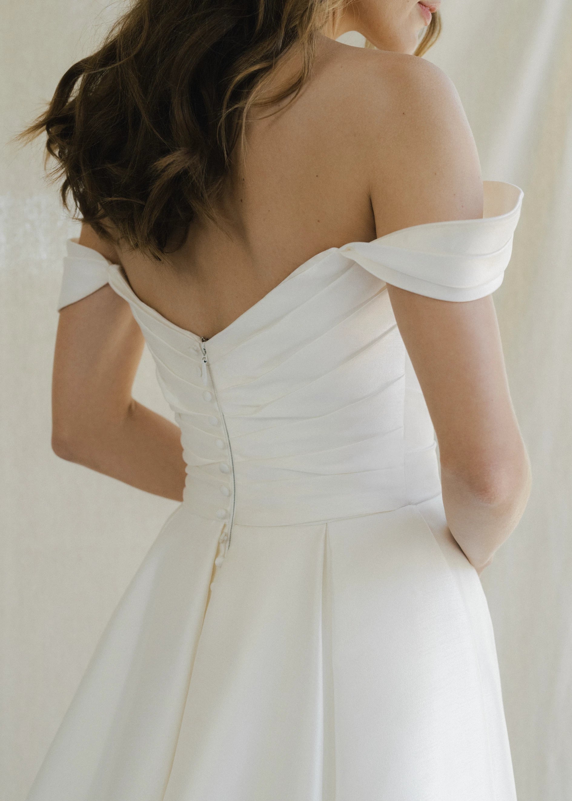 The Blue Willow Tucker Overskirt is a dramatic pleated overskirt of Soft Mikado in Pearl and Bright White.
