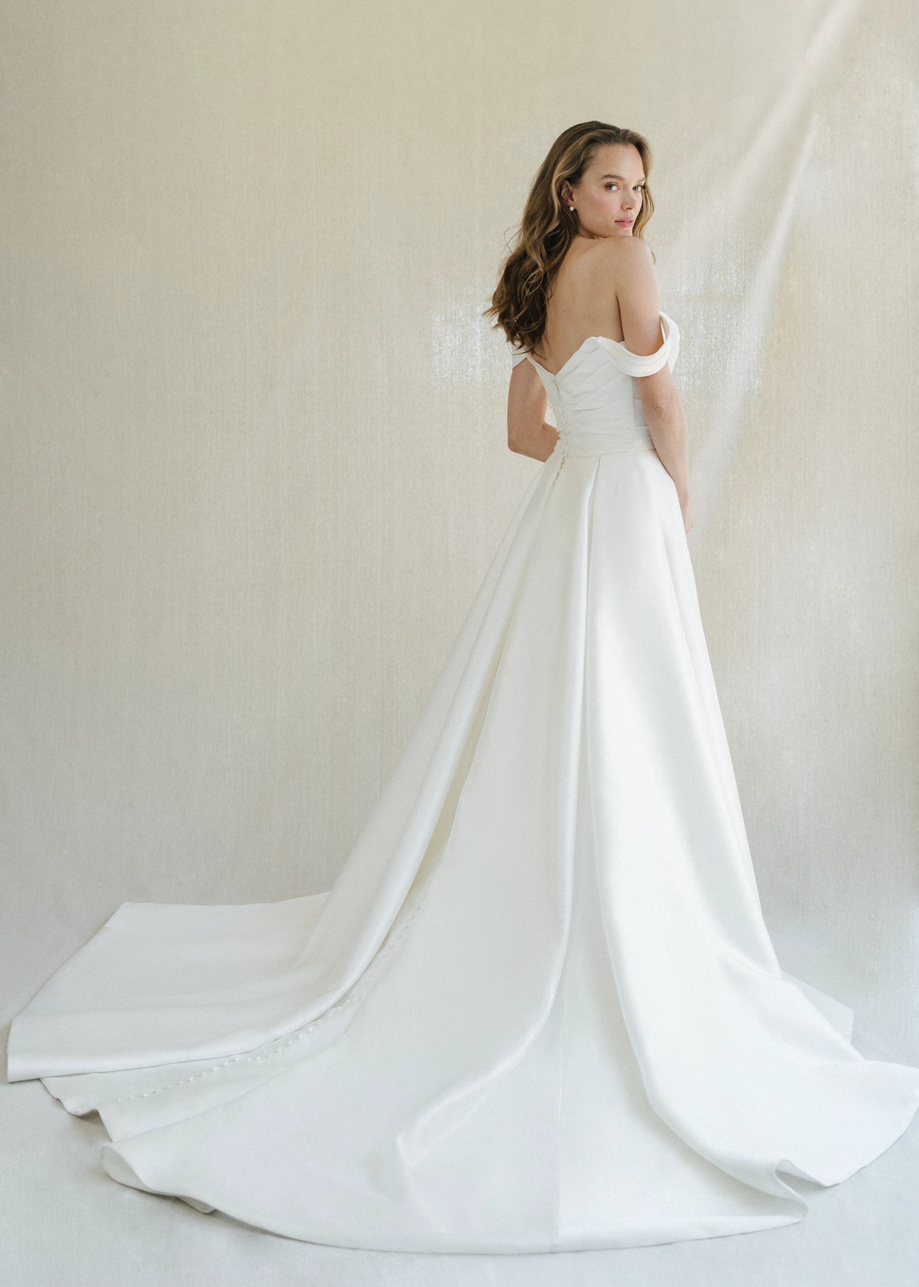 The Blue Willow Tucker Overskirt is a dramatic pleated overskirt of Soft Mikado in Pearl and Bright White.