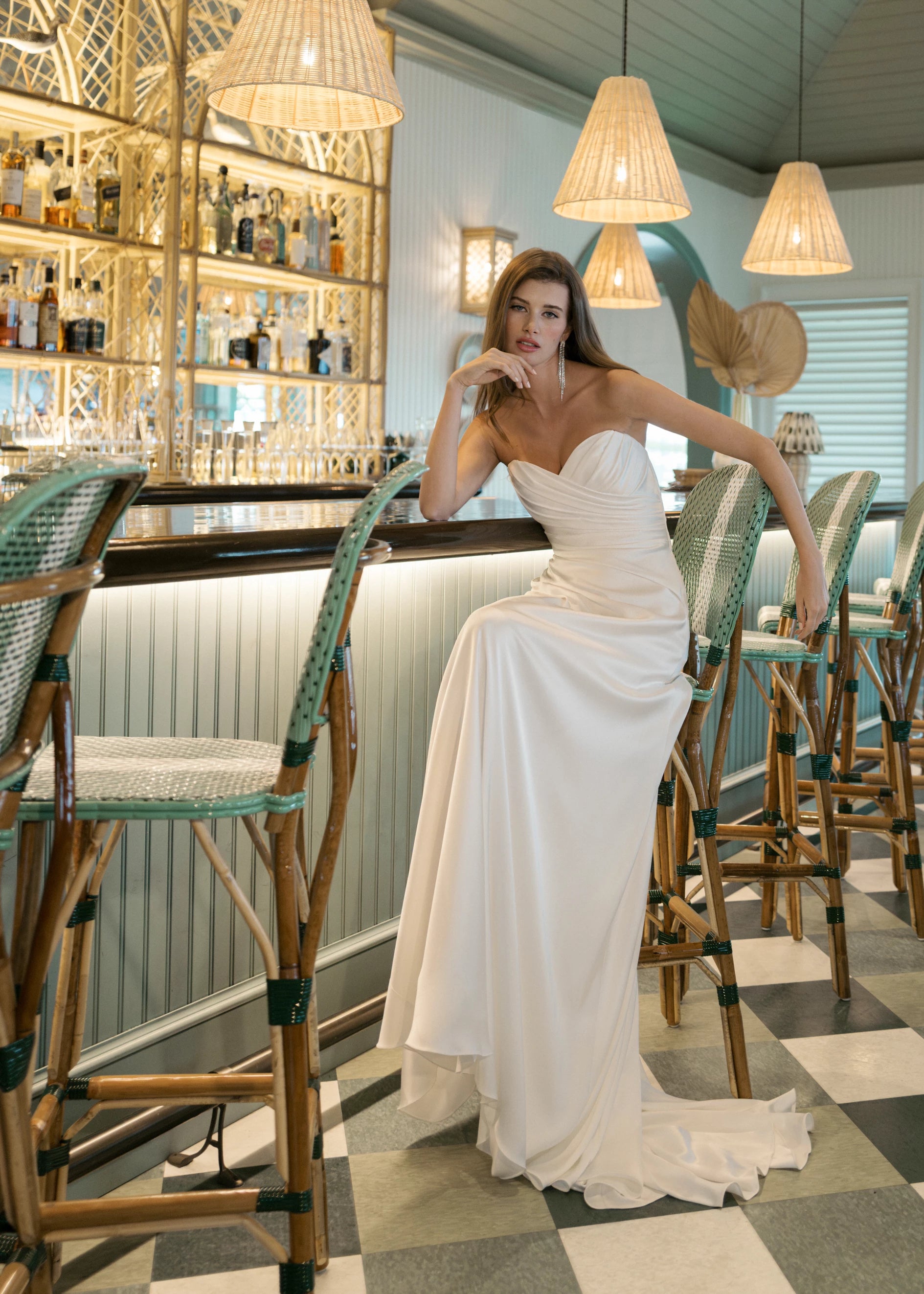 The Carlson gown is a sweetheart column gown of Double Faced Charmeuse with bodice draping opening to a draped cascading skirt in Silk White.