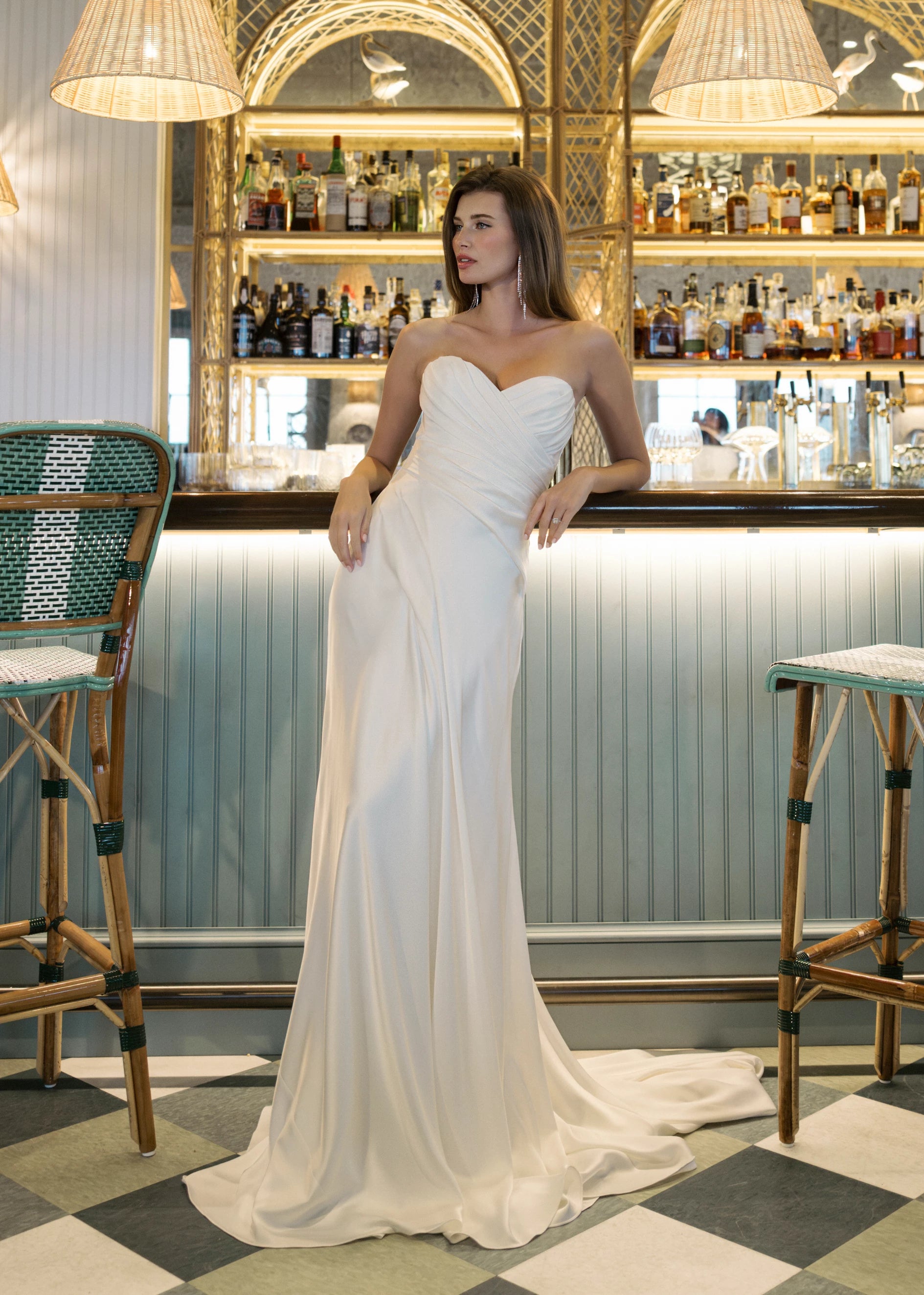 The Carlson gown is a sweetheart column gown of Double Faced Charmeuse with bodice draping opening to a draped cascading skirt in Silk White.