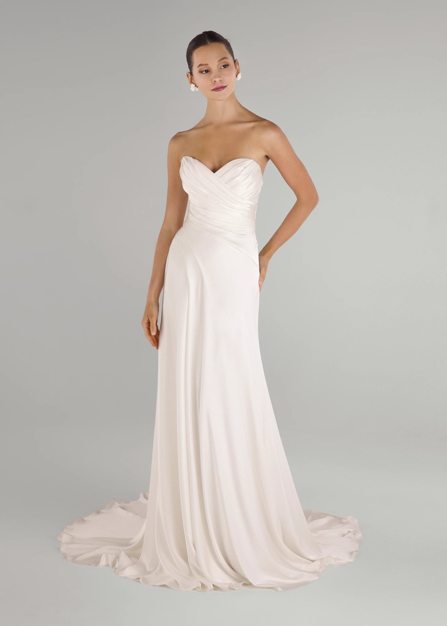 The Carlson gown is a sweetheart column gown of Double Faced Charmeuse with bodice draping opening to a draped cascading skirt in Silk White.