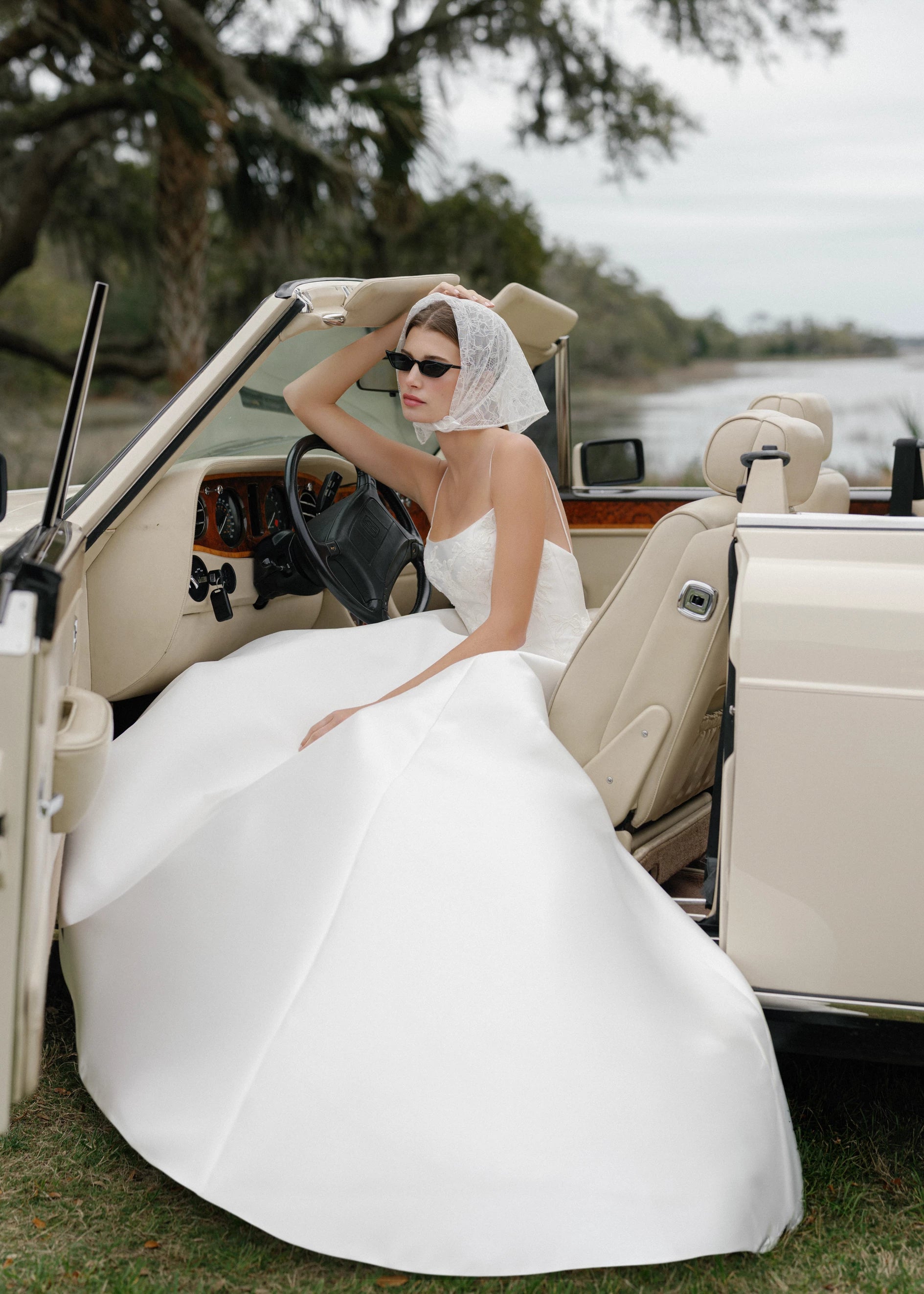 The Charlie gown is a scoopneck spaghetti strap A-line gown of Soft Mikado with Sequined Corded Floral Lattice appliqués in Pearl.
