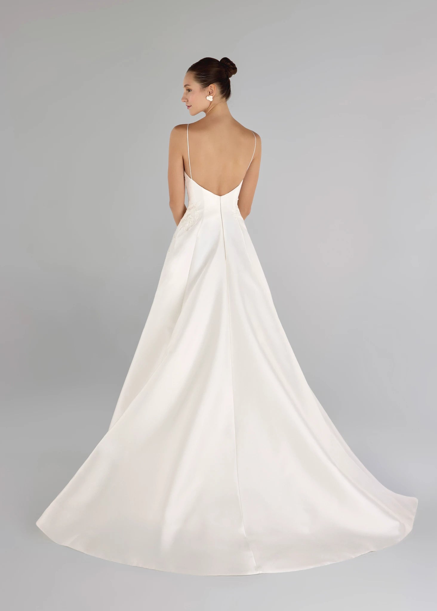 The Charlie gown is a scoopneck spaghetti strap A-line gown of Soft Mikado with Sequined Corded Floral Lattice appliqués in Pearl.