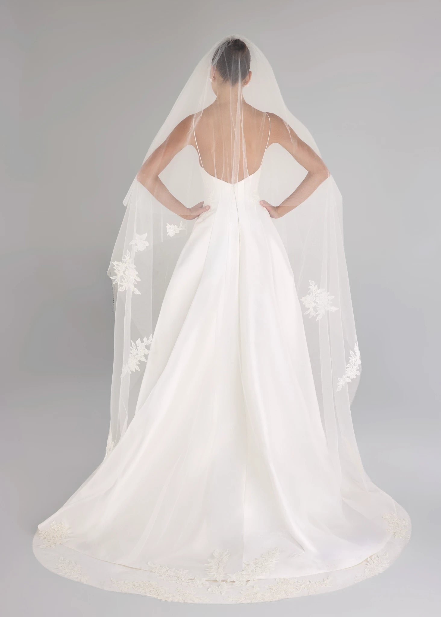 The Blue Willow Charlie Veil is a cathedral length veil with Sequined Corded Floral Lattice appliqués in Silk White, complete with 32" foldover blusher and 98" length.