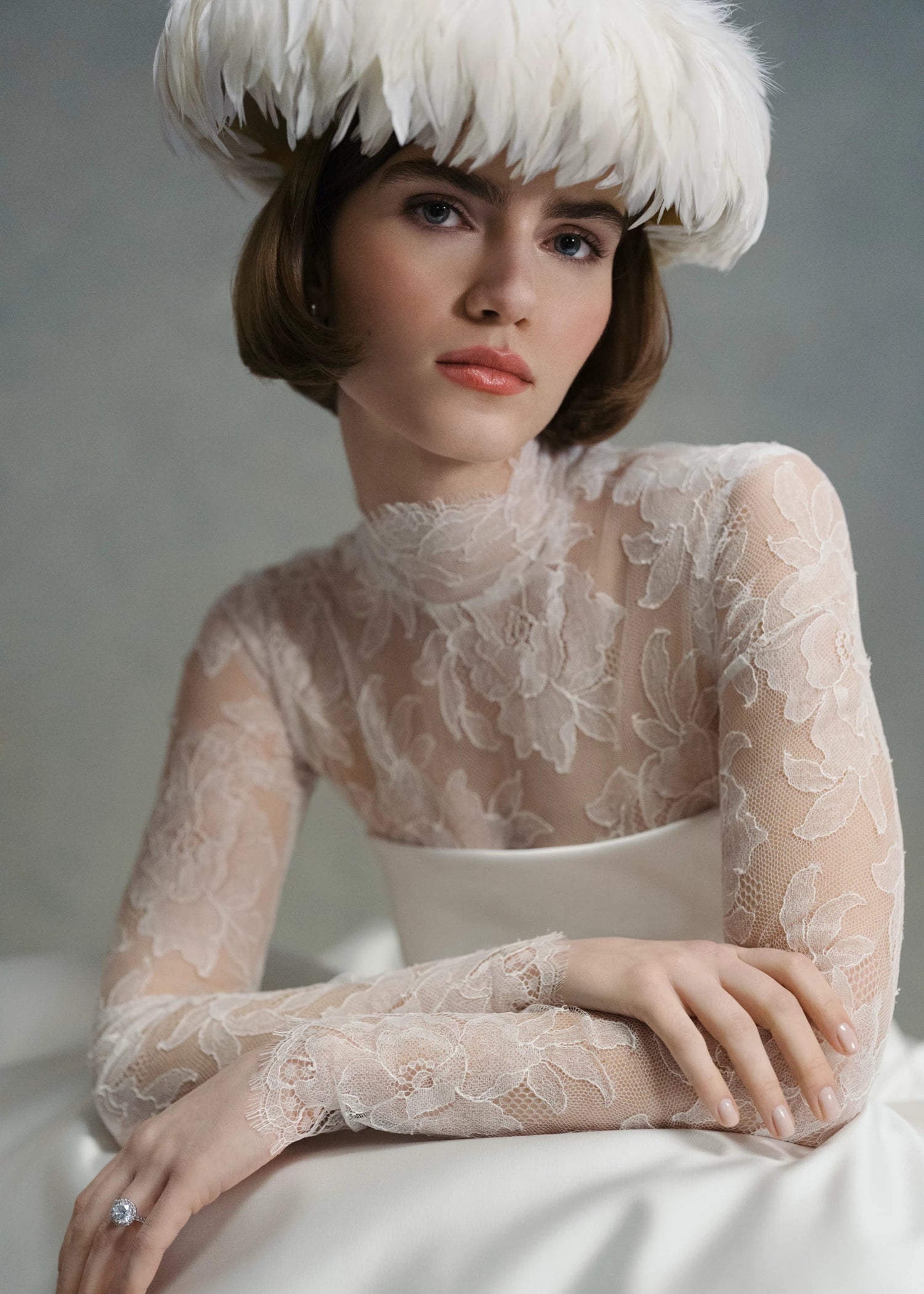 The Cyrus Topper by Anne Barge, a long sleeve mockneck top of Chantilly lace with lace-covered buttons and loops at back and wrists in Silk White.
