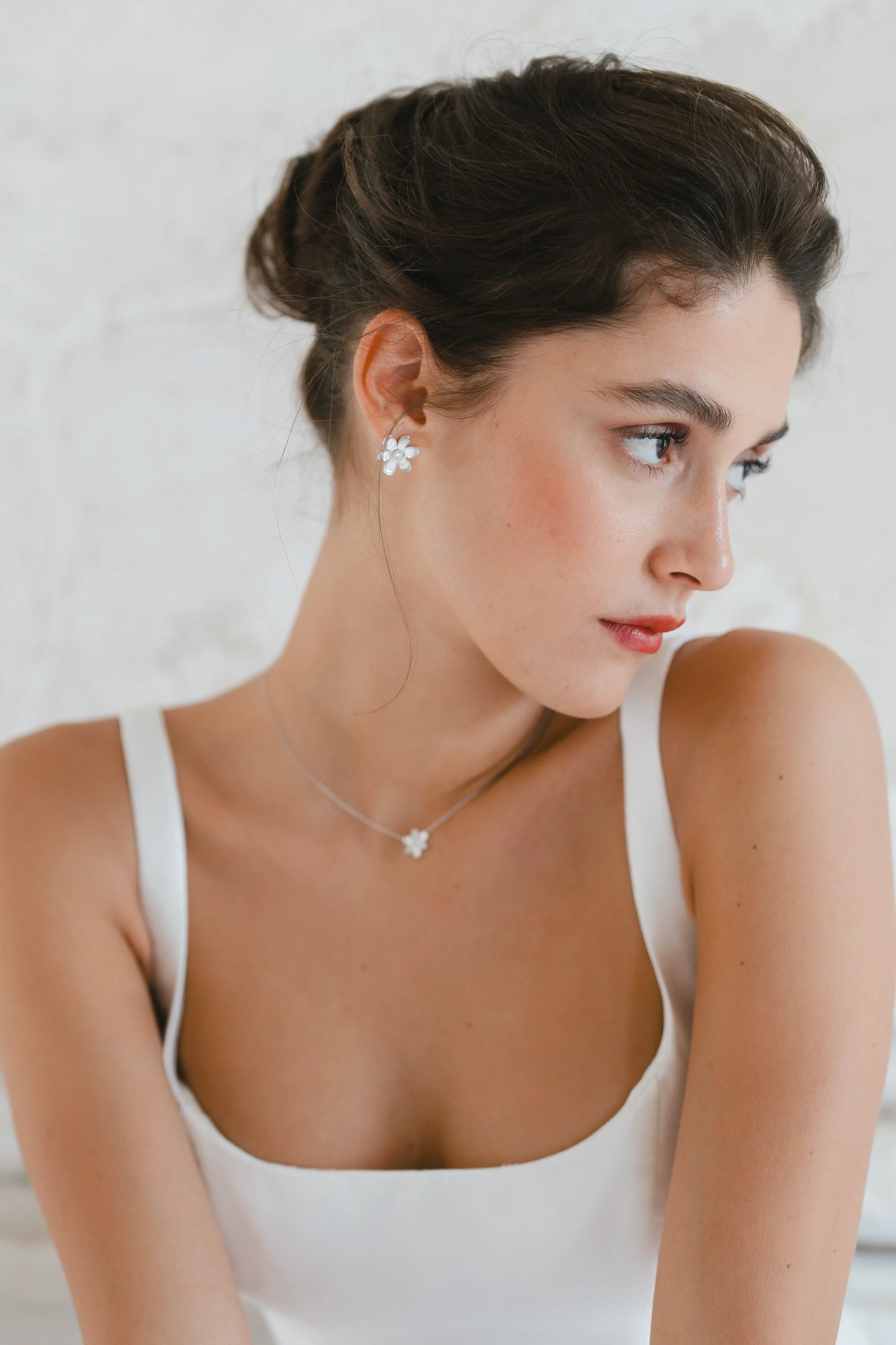 Designed by Atlanta jewelry designer Laura Pearce, delicate Daisy flower studs, featuring a 0.20 CTTW brilliant diamond.