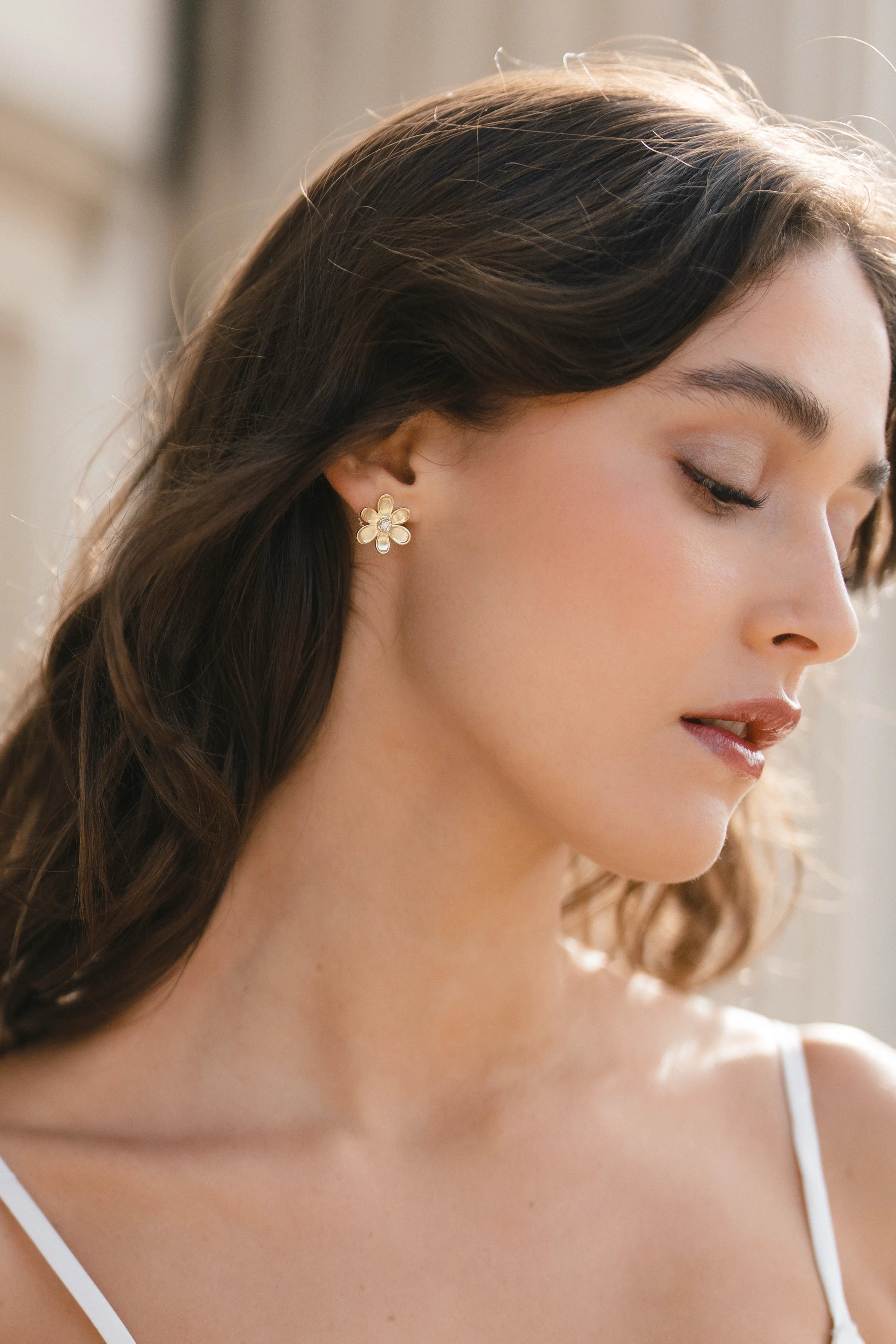 Designed by Atlanta jewelry designer Laura Pearce, delicate Daisy flower studs, featuring a 0.20 CTTW brilliant diamond.