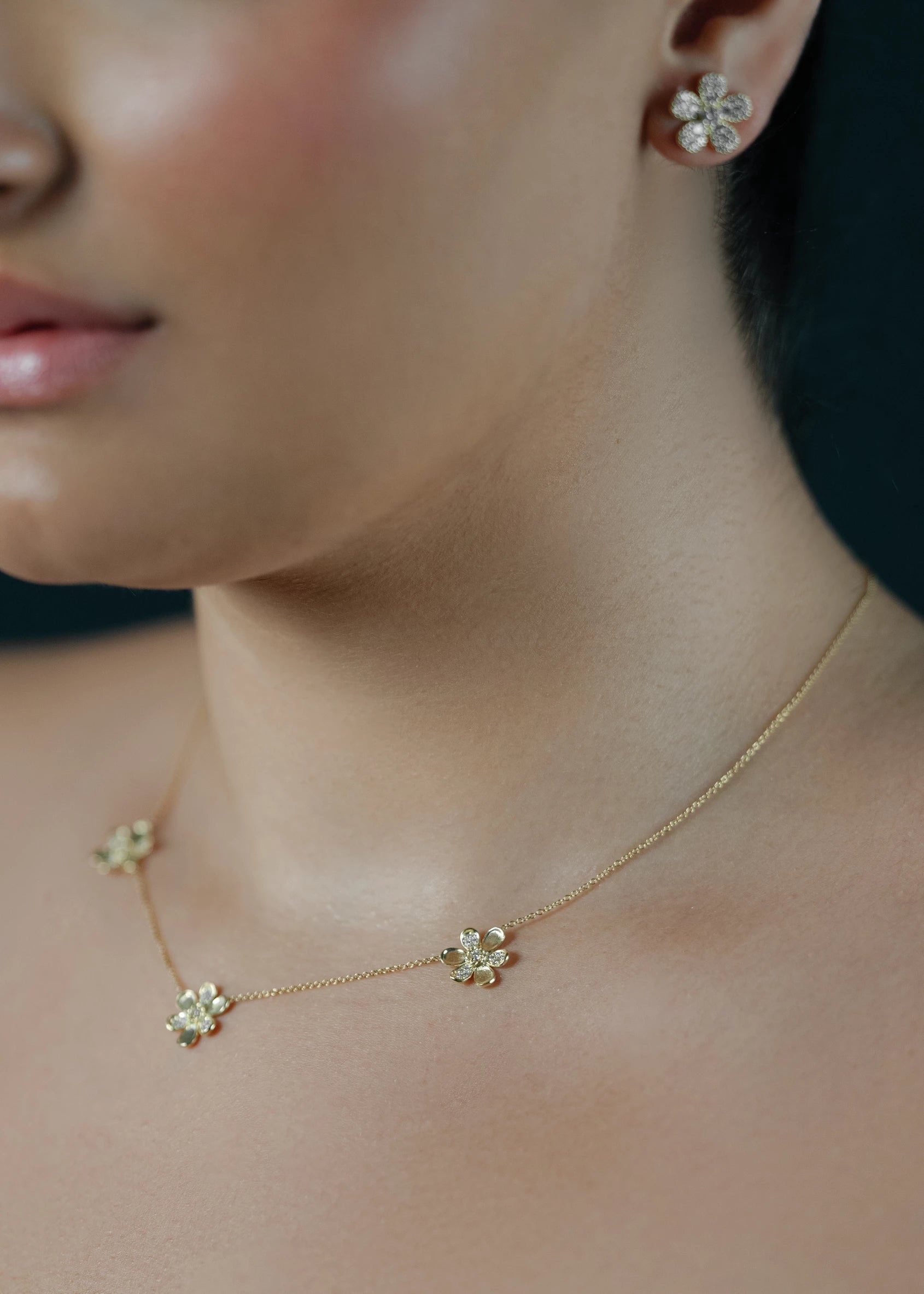 Designed by Atlanta jewelry designer Laura Pearce, three delicate pavé diamond flowers on a 16" strand, featuring 0.27 CTTW of brilliant diamonds and available in 18K Yellow or White Gold.