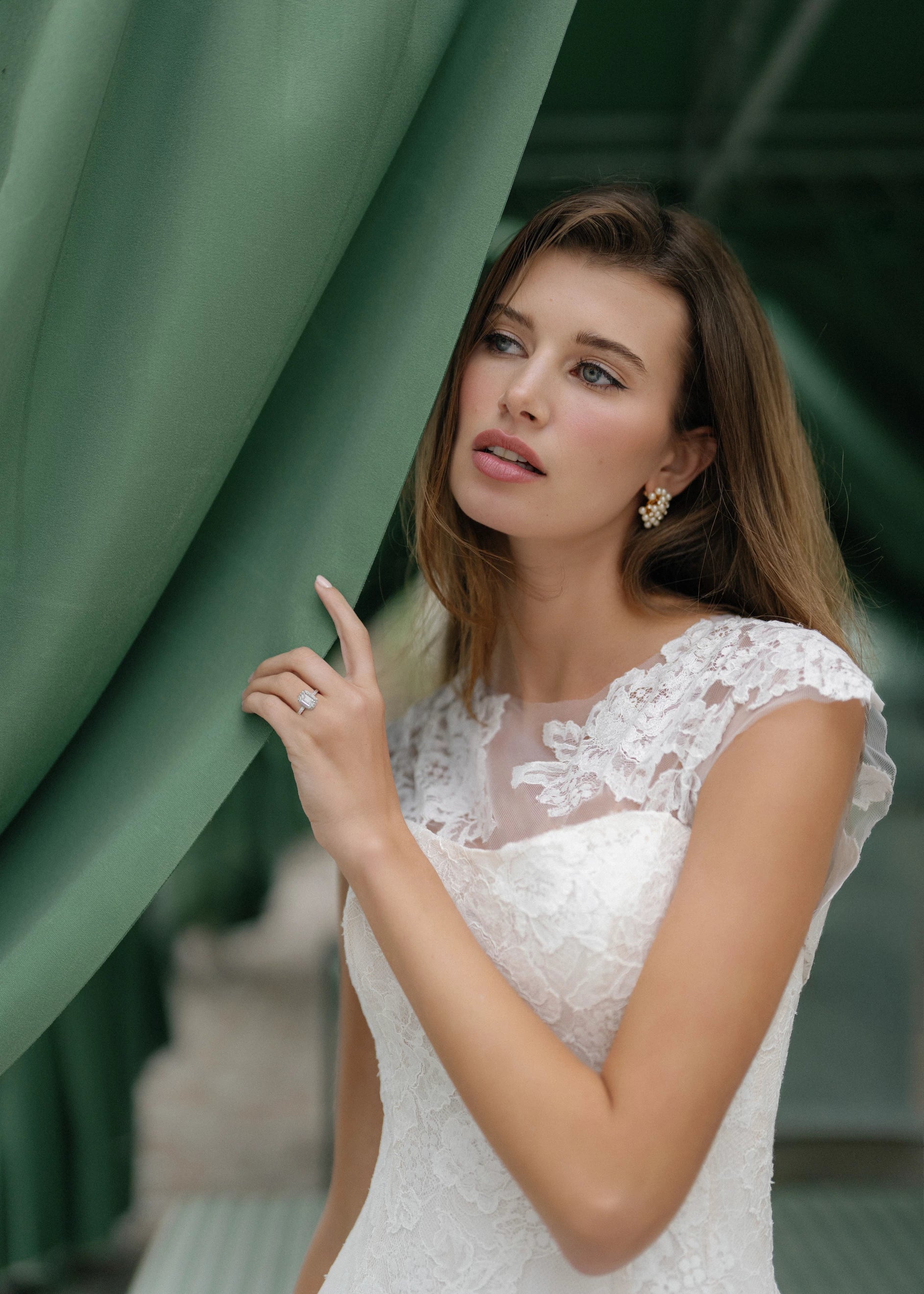 The Blue Willow Dunlin Topper is a cap sleeve Illusion tulle top with Blossom Corded Lace appliques in Silk White that can be worn over or under a gown.