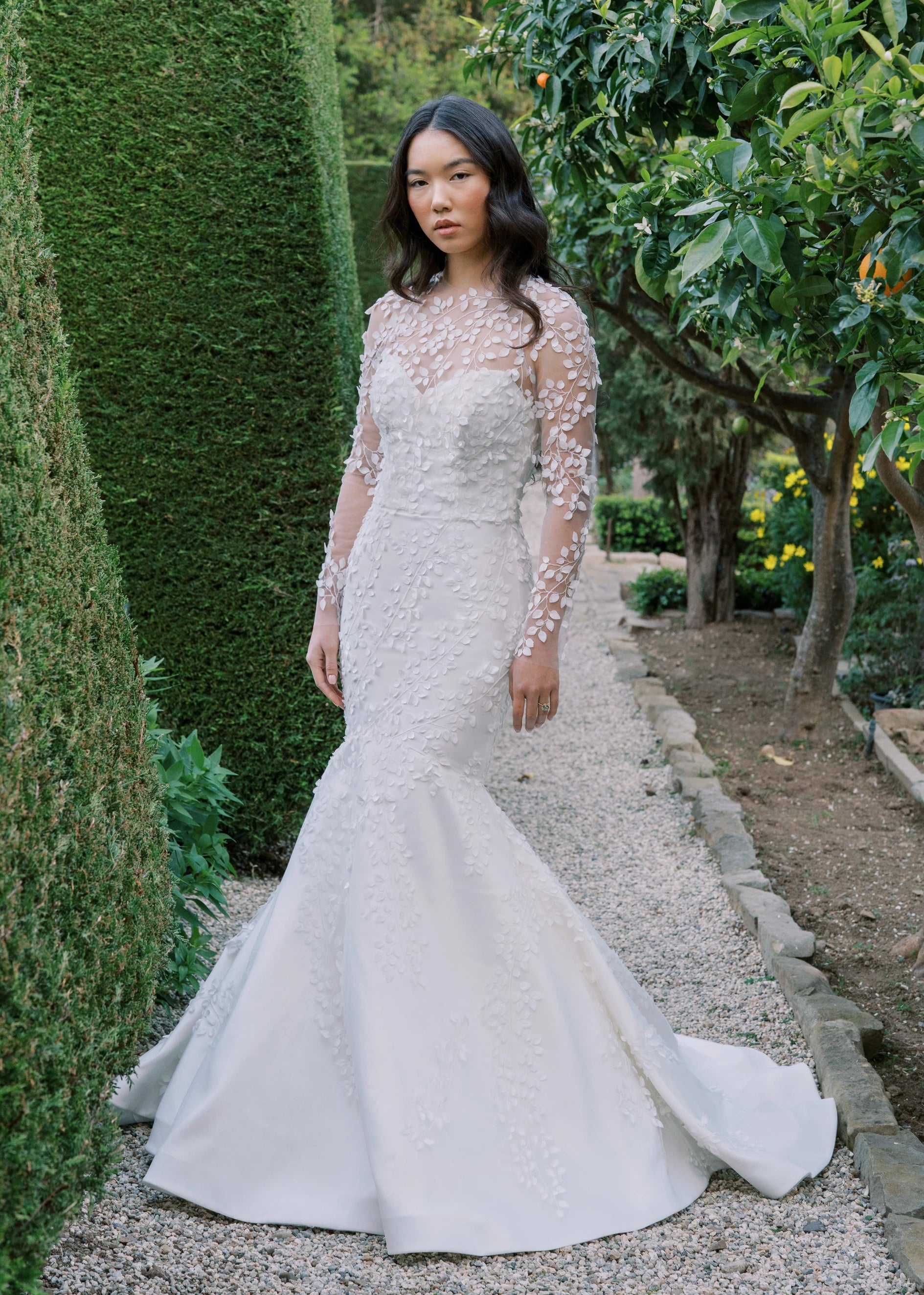 The Blue Willow Fleur De Lis Topper, an illusion long sleeved top with 3D leaf embroidery in Silk White.