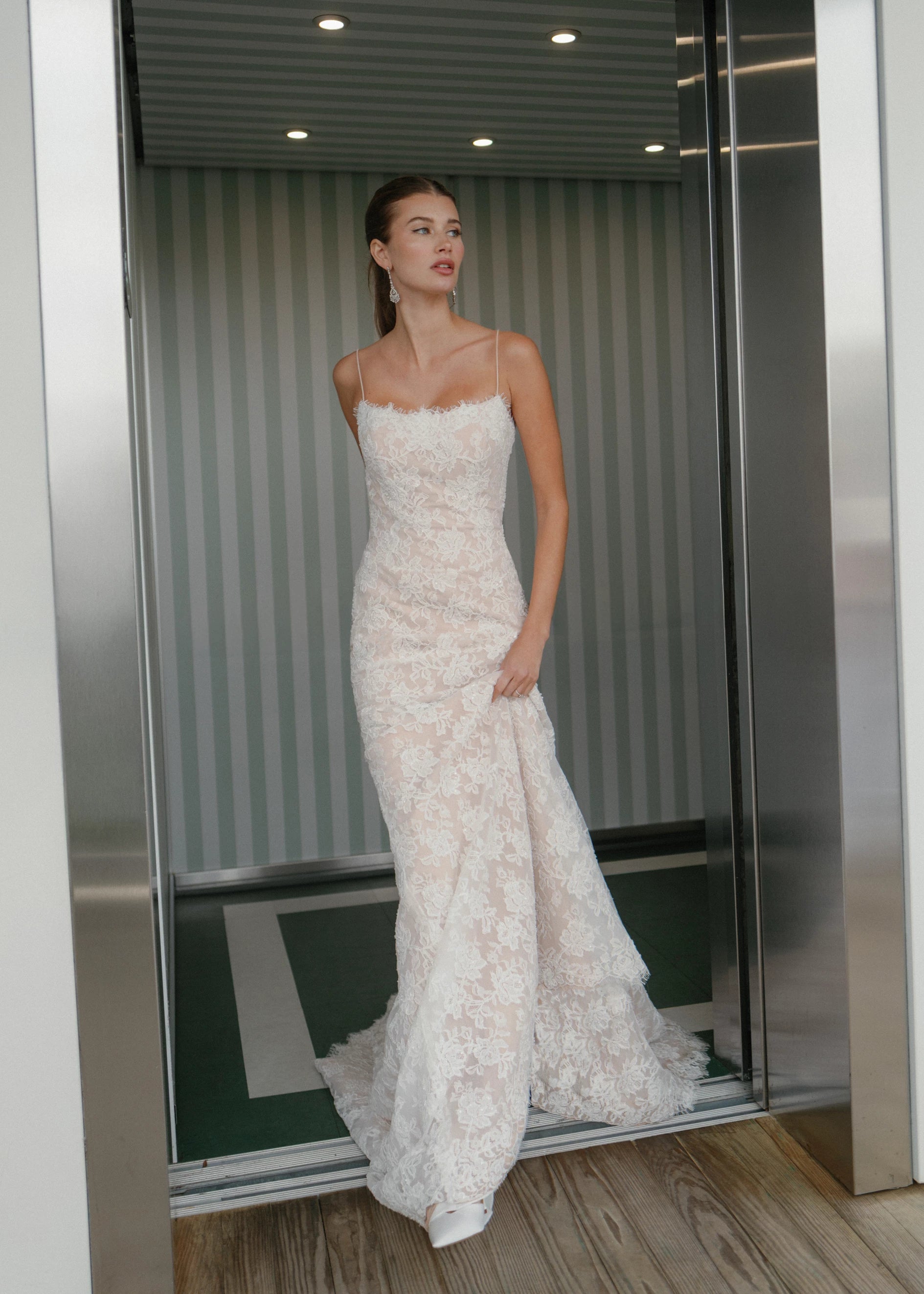 The Gibbes gown is a soft scoop neckline fit-to-flare gown of Beaded Floral Corded Lace with a curved waist seam.