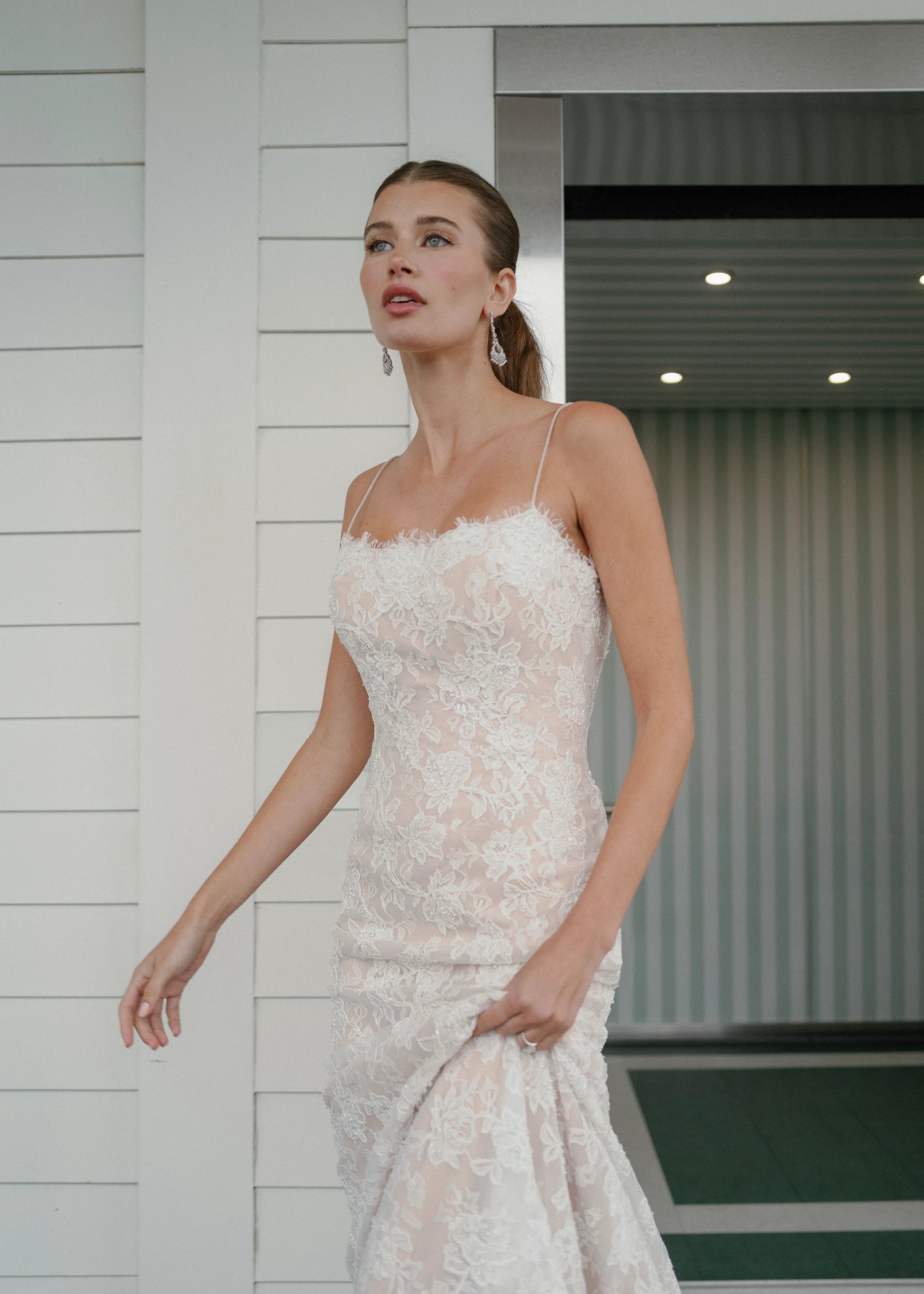 The Gibbes gown is a soft scoop neckline fit-to-flare gown of Beaded Floral Corded Lace with a curved waist seam.