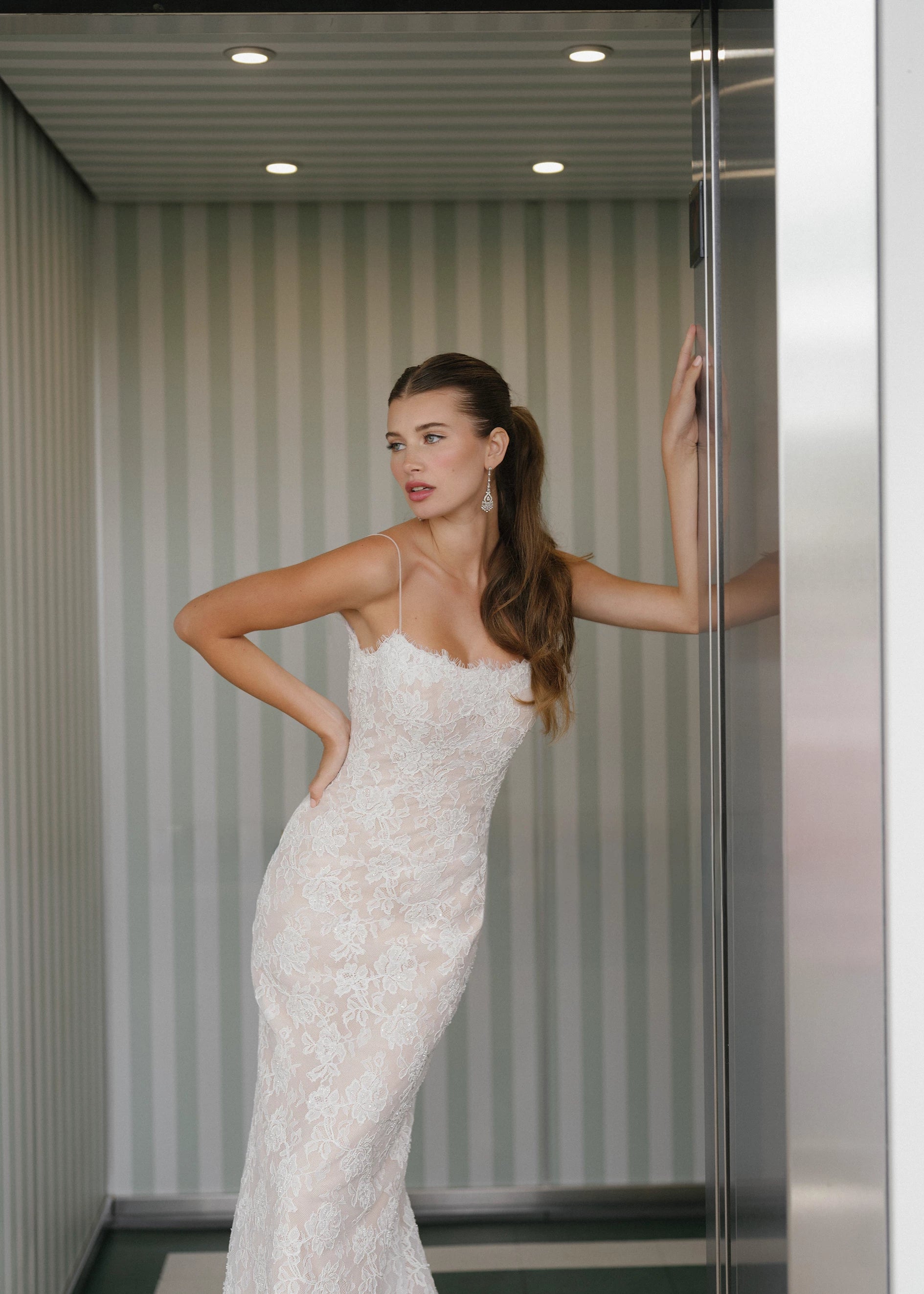The Gibbes gown is a soft scoop neckline fit-to-flare gown of Beaded Floral Corded Lace with a curved waist seam.