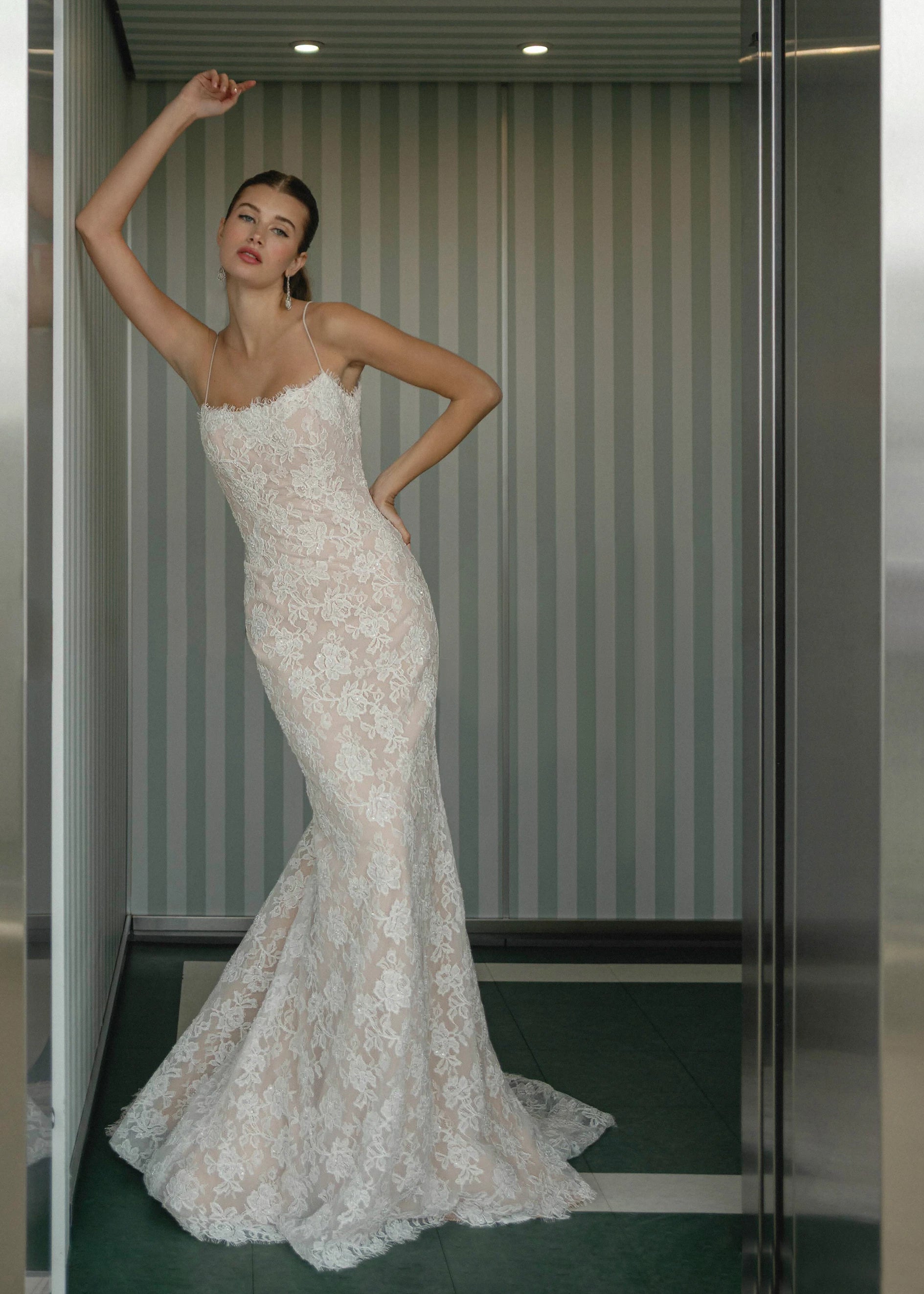 The Gibbes gown is a soft scoop neckline fit-to-flare gown of Beaded Floral Corded Lace with a curved waist seam
