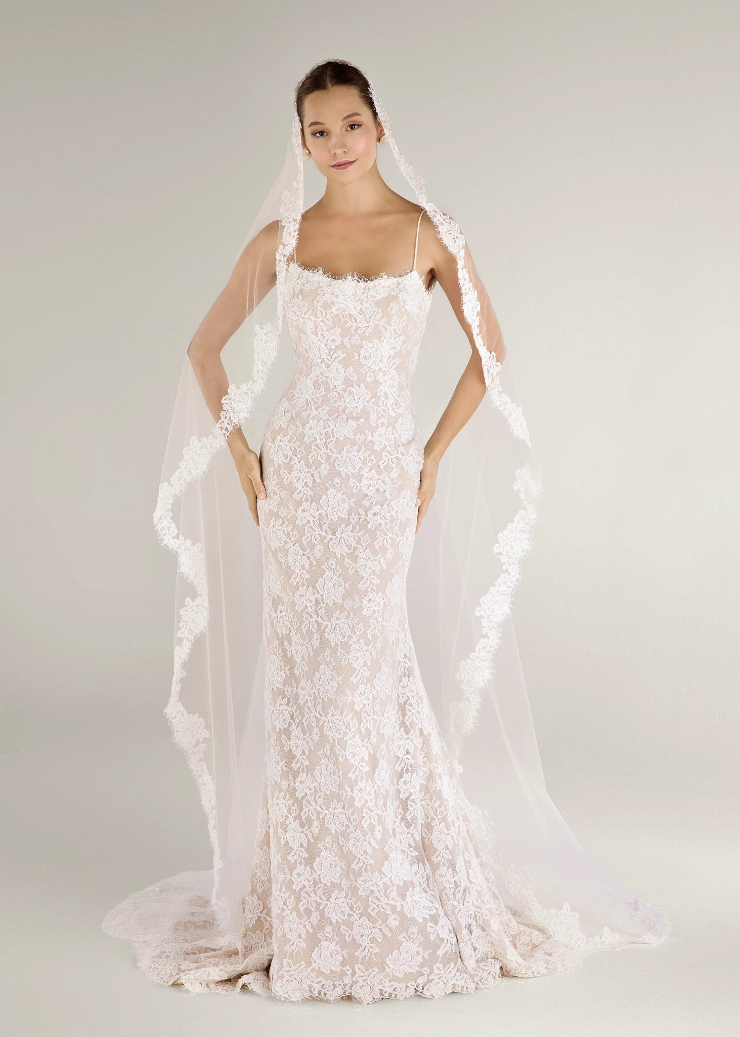 The Blue Willow Gibbes Veil is a chapel mantilla veil with Beaded Floral Corded Lace edge in Silk White and 95" length.
