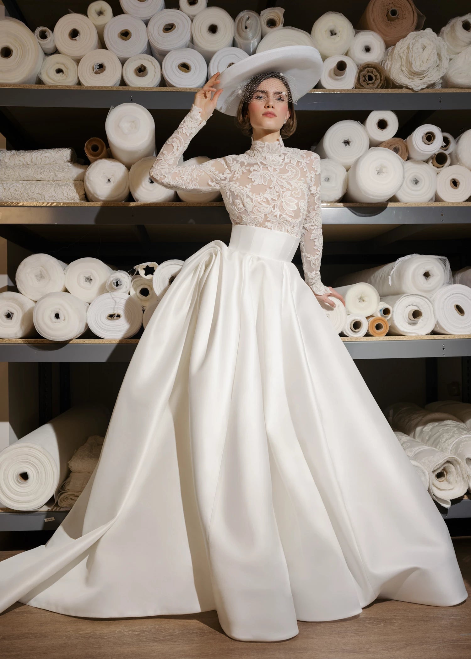 The Gigi Topper by Anne Barge is an Illusion tulle long sleeve mockneck top appliquéd with French Alençon lace in Silk White.