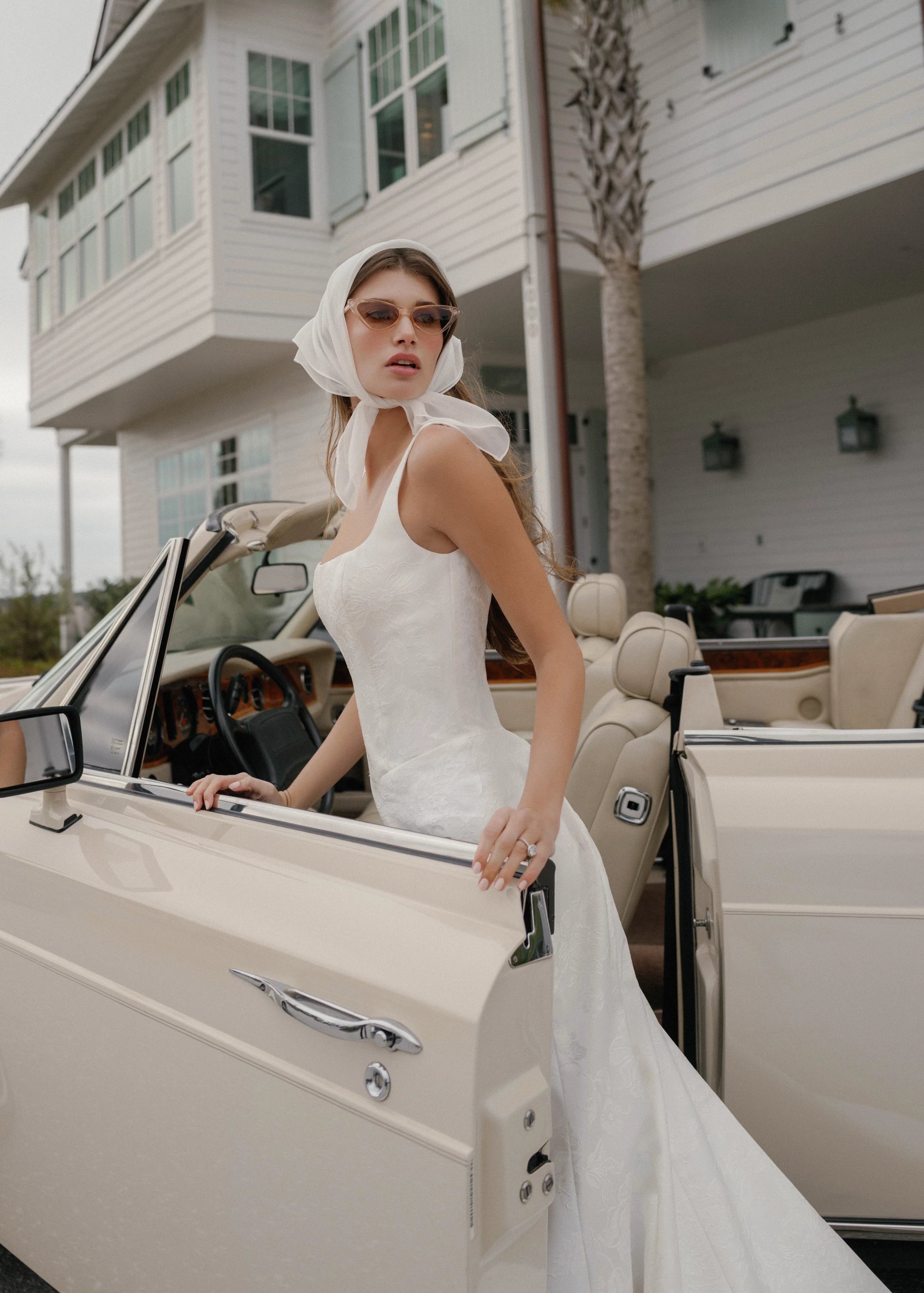 The Kiawah gown is a square neckline fit and flare gown of Embossed Jacquard with curved drop waist in Pearl.