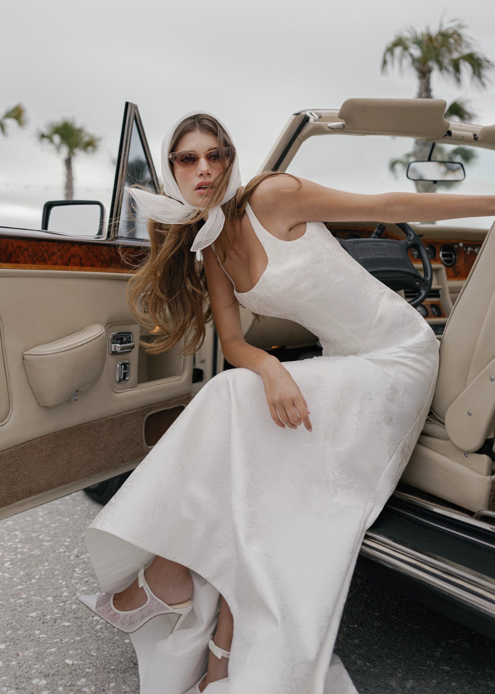 The Kiawah gown is a square neckline fit and flare gown of Embossed Jacquard with curved drop waist in Pearl.