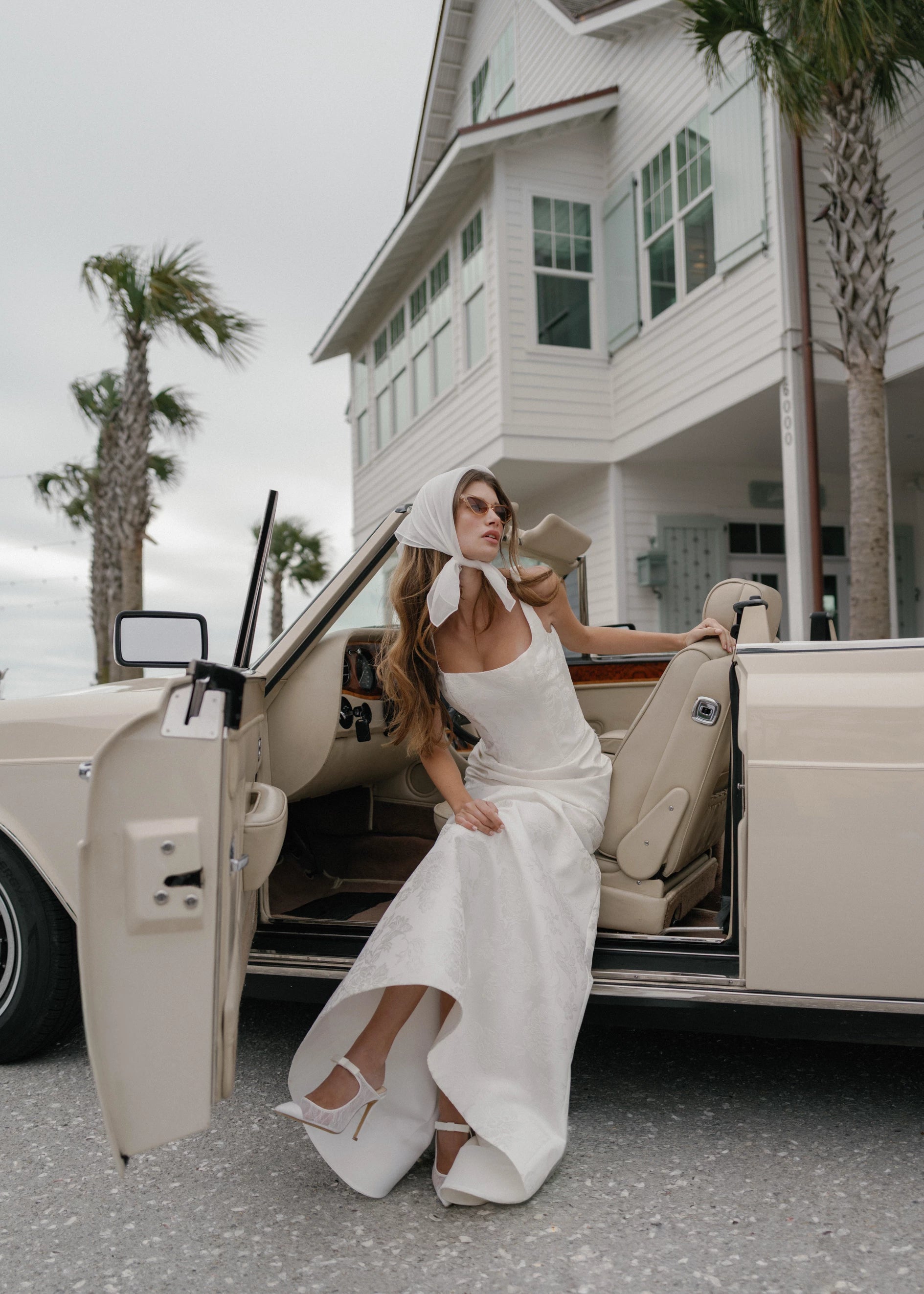 The Kiawah gown is a square neckline fit and flare gown of Embossed Jacquard with curved drop waist in Pearl.