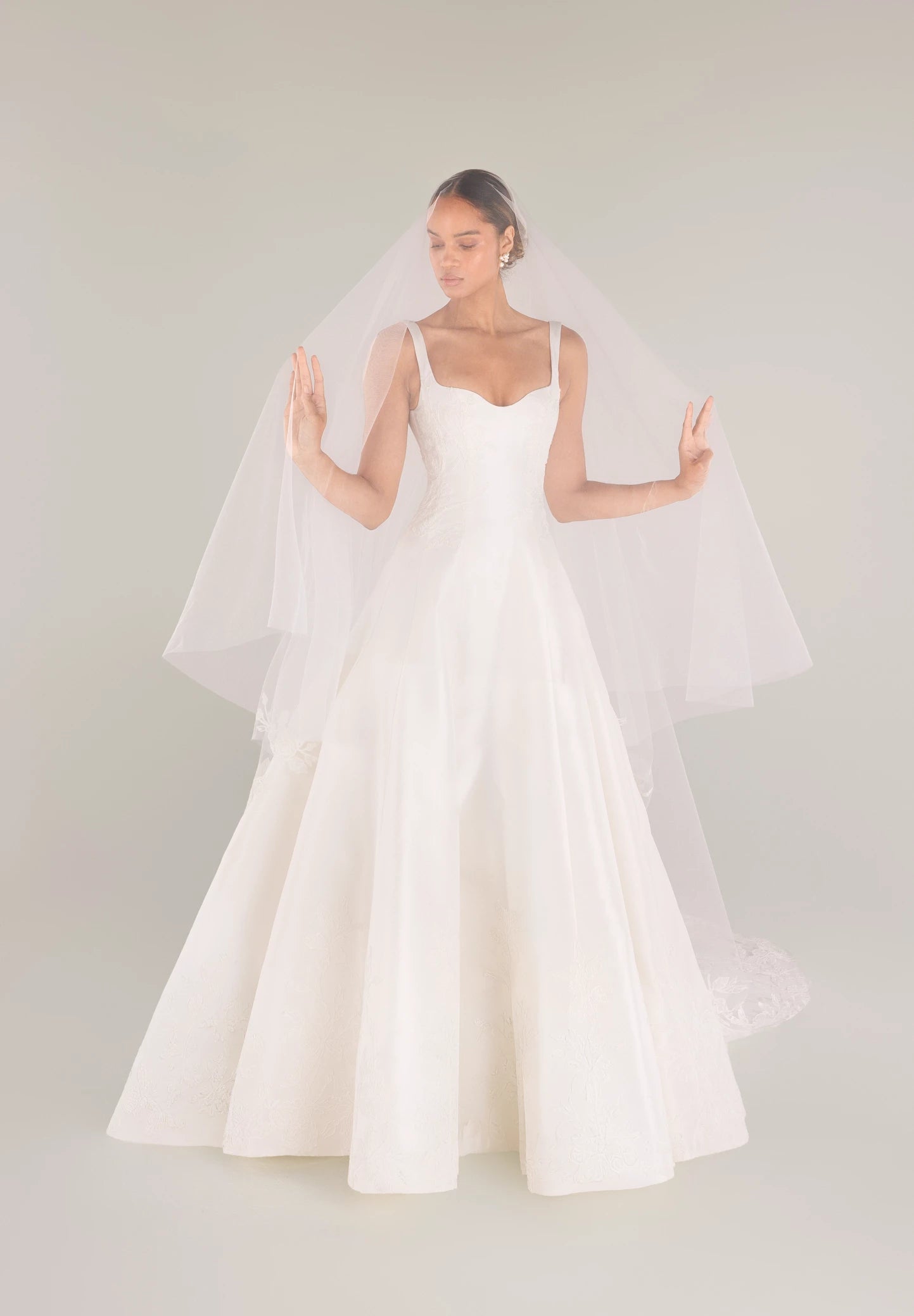 The King gown is a softly contoured sweetheart neckline A-line gown of Italian Kalika with Floral Vine Embroidered Lace appliqués framing the bodice and all around the skirt hem in Silk White.