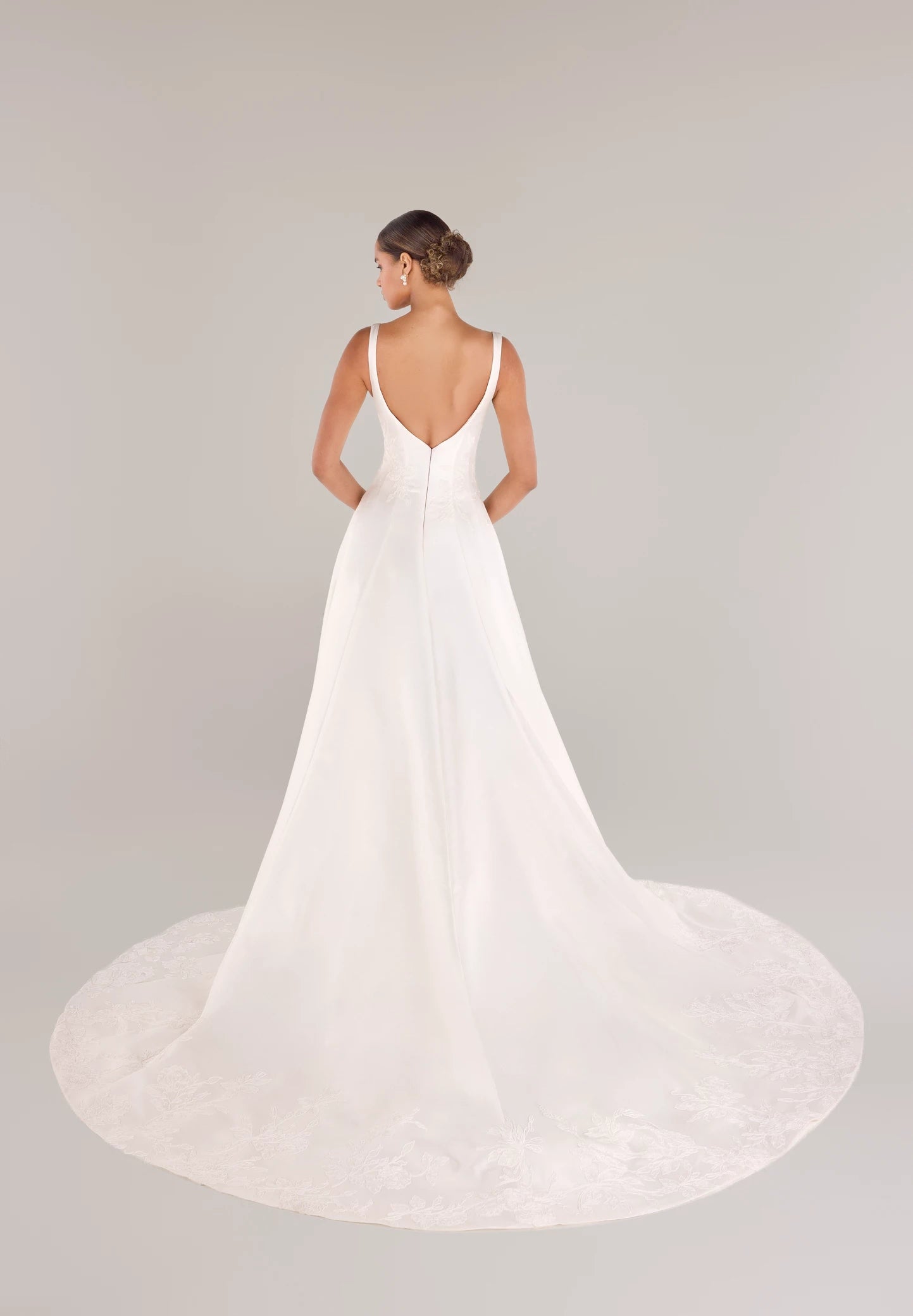 The King gown is a softly contoured sweetheart neckline A-line gown of Italian Kalika with Floral Vine Embroidered Lace appliqués framing the bodice and all around the skirt hem in Silk White.