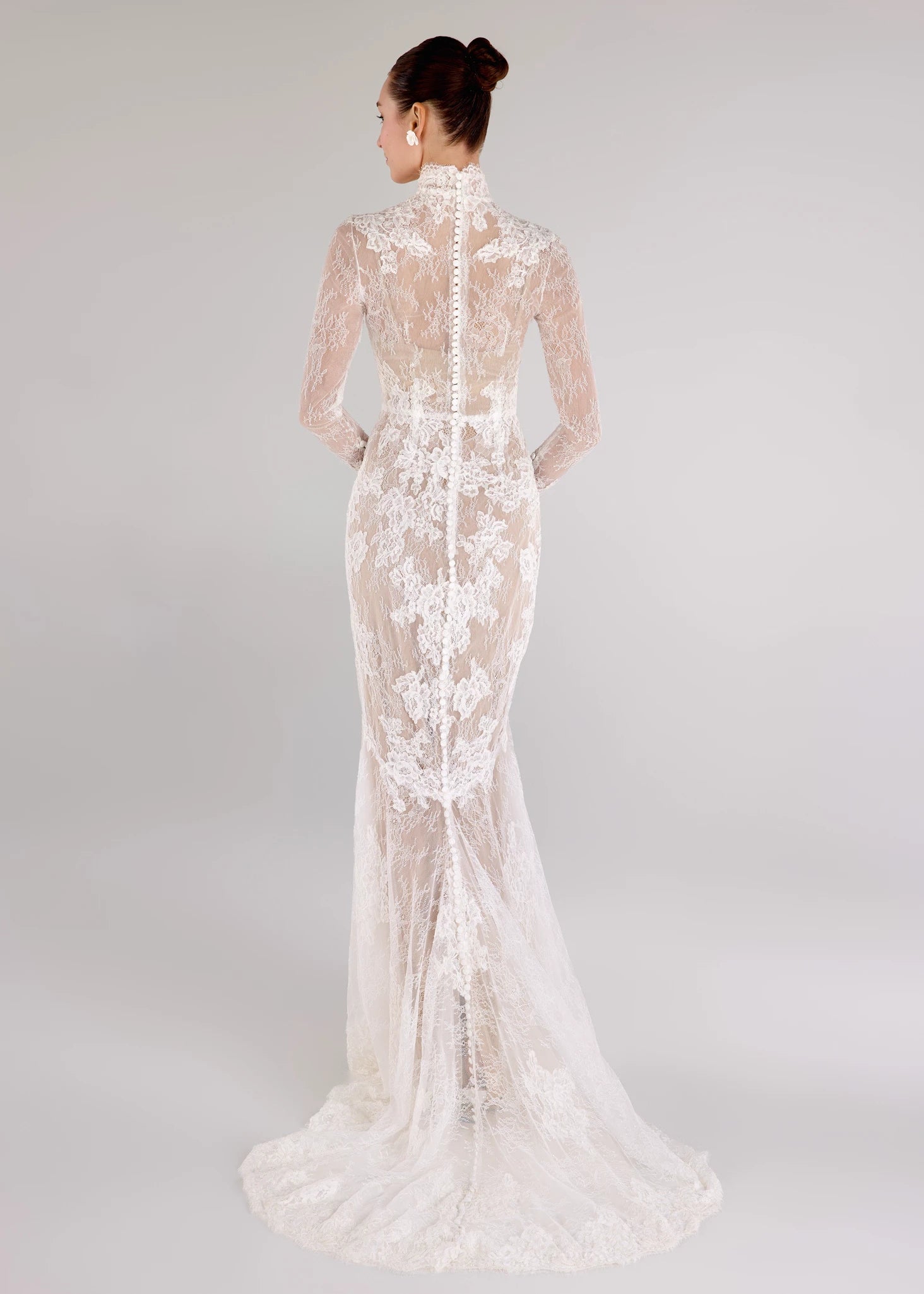 The Leo gown is a mockneck long sleeve columnar gown of Corded Lace gown with Chantilly lace underlay in Silk White. Shown with the Leo Slip; a powernet slip available as a separate piece