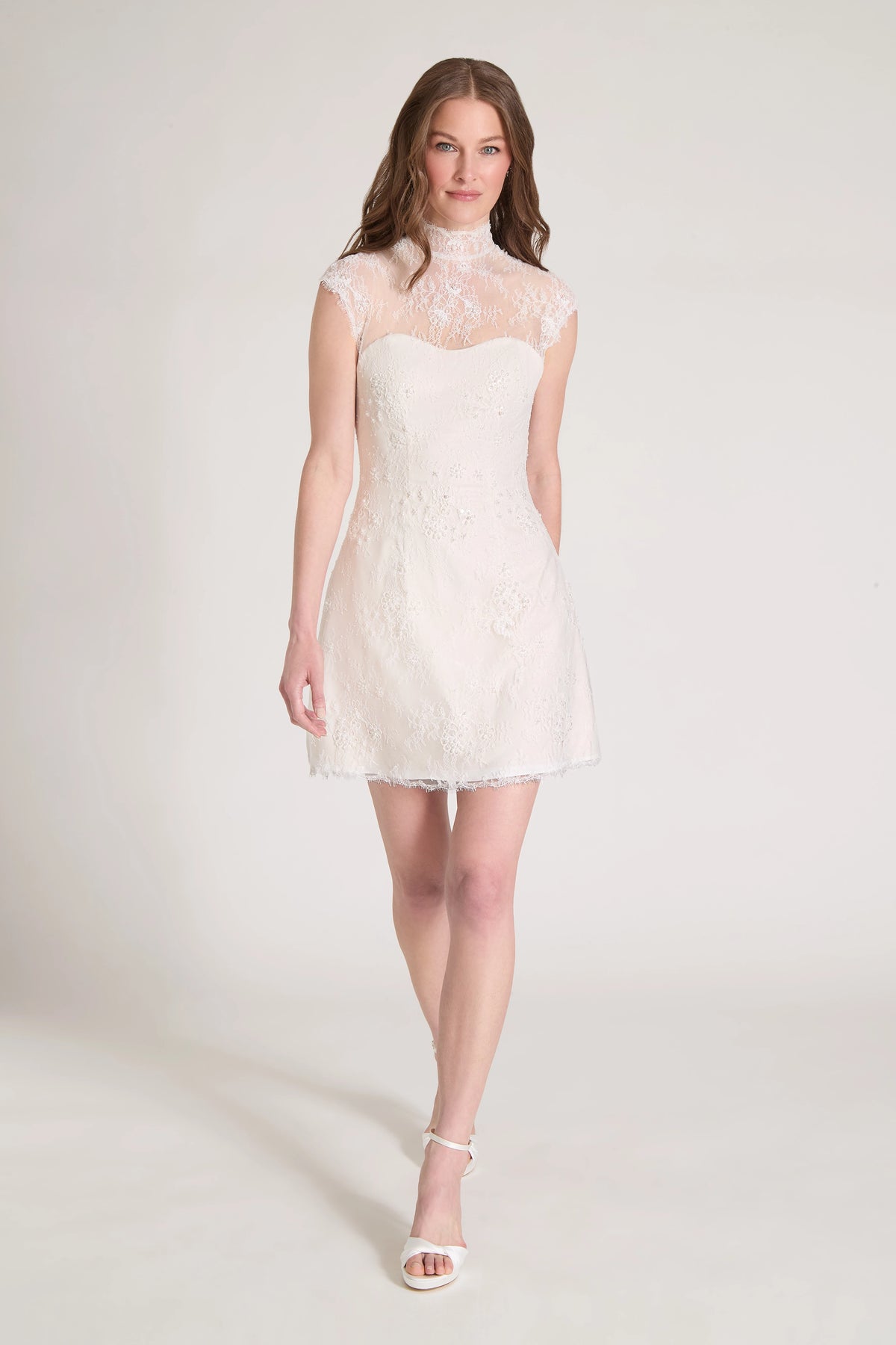 The Blush Crush Little White Dress is a mockneck cap sleeve mini dress of Corded Beaded Chantilly Lace with soft nude tulle underlay in Silk White/Nude.