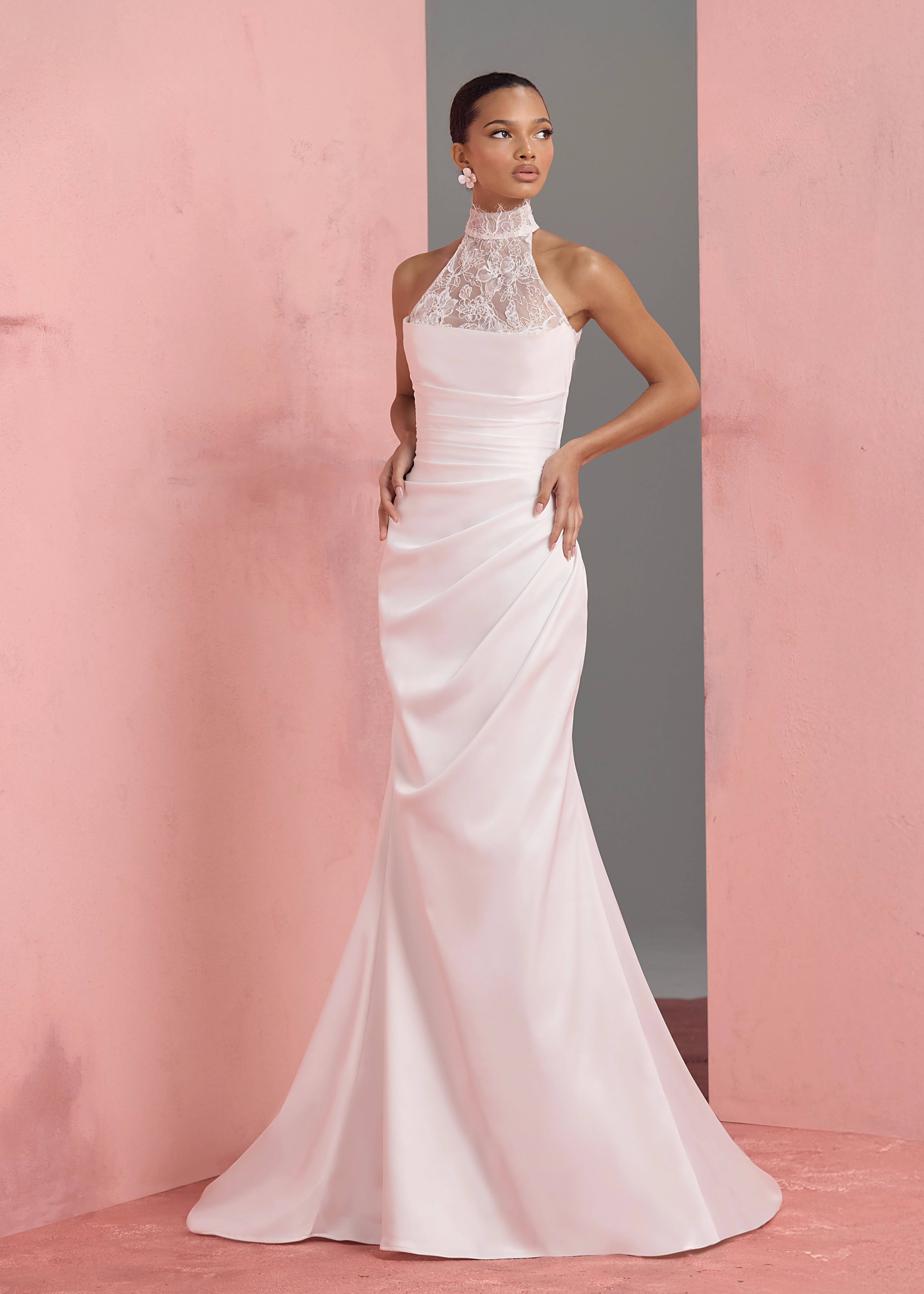 The Marielle gown by Anne Barge is a dramatically draped column gown of Crepe Back Satin featuring a peek-a-boo sweetheart neckline with Petal Beaded Embroidery. Shown with the Marielle Top, a halter neck illusion tulle top of Petal Beaded Embroidery.