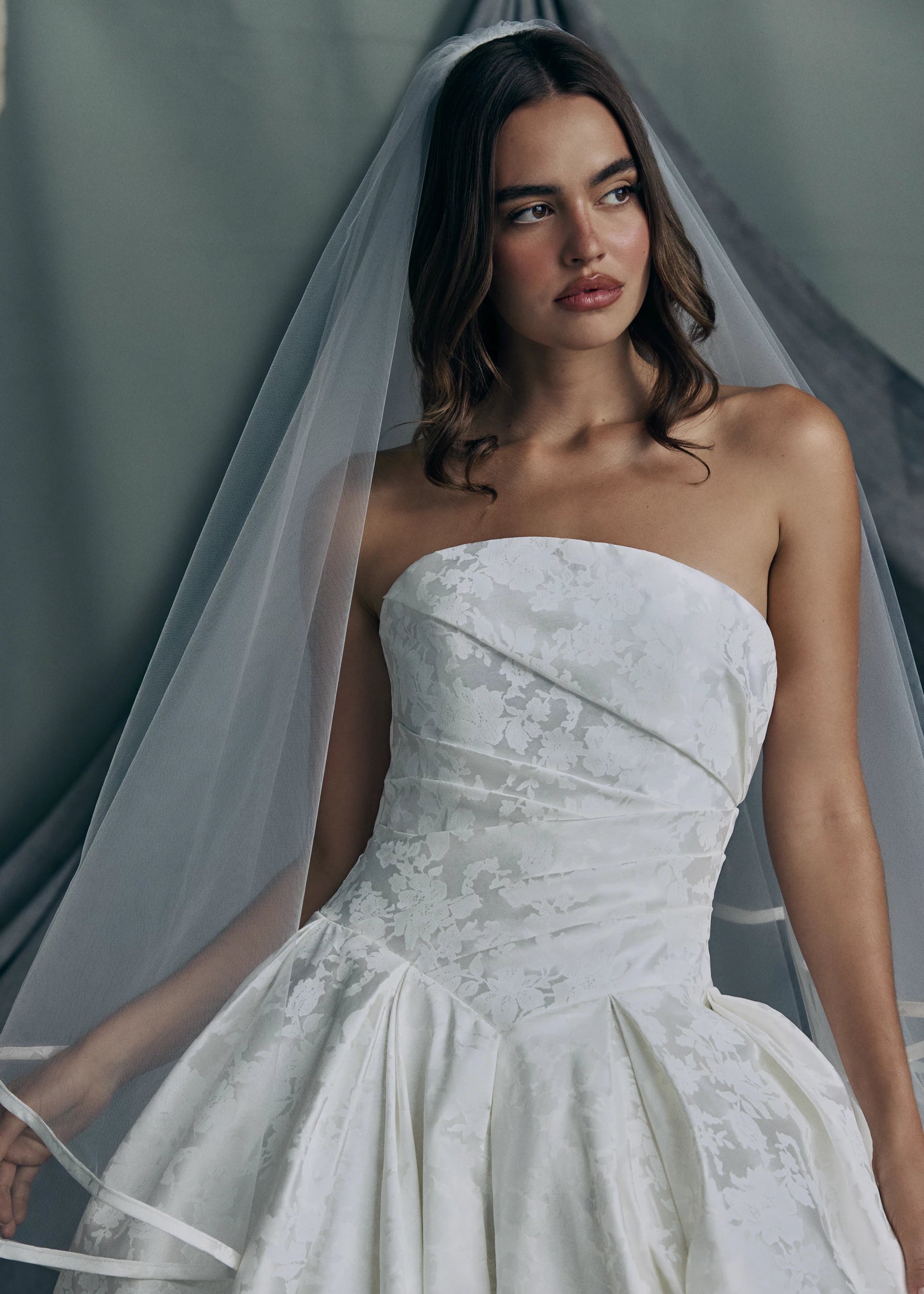 The Monarch gown by Anne Barge paired with the The Monarch Veil, a cathedral length veil with foldover blusher, outlined with single band of Italian Lace Printed Matte Satin.