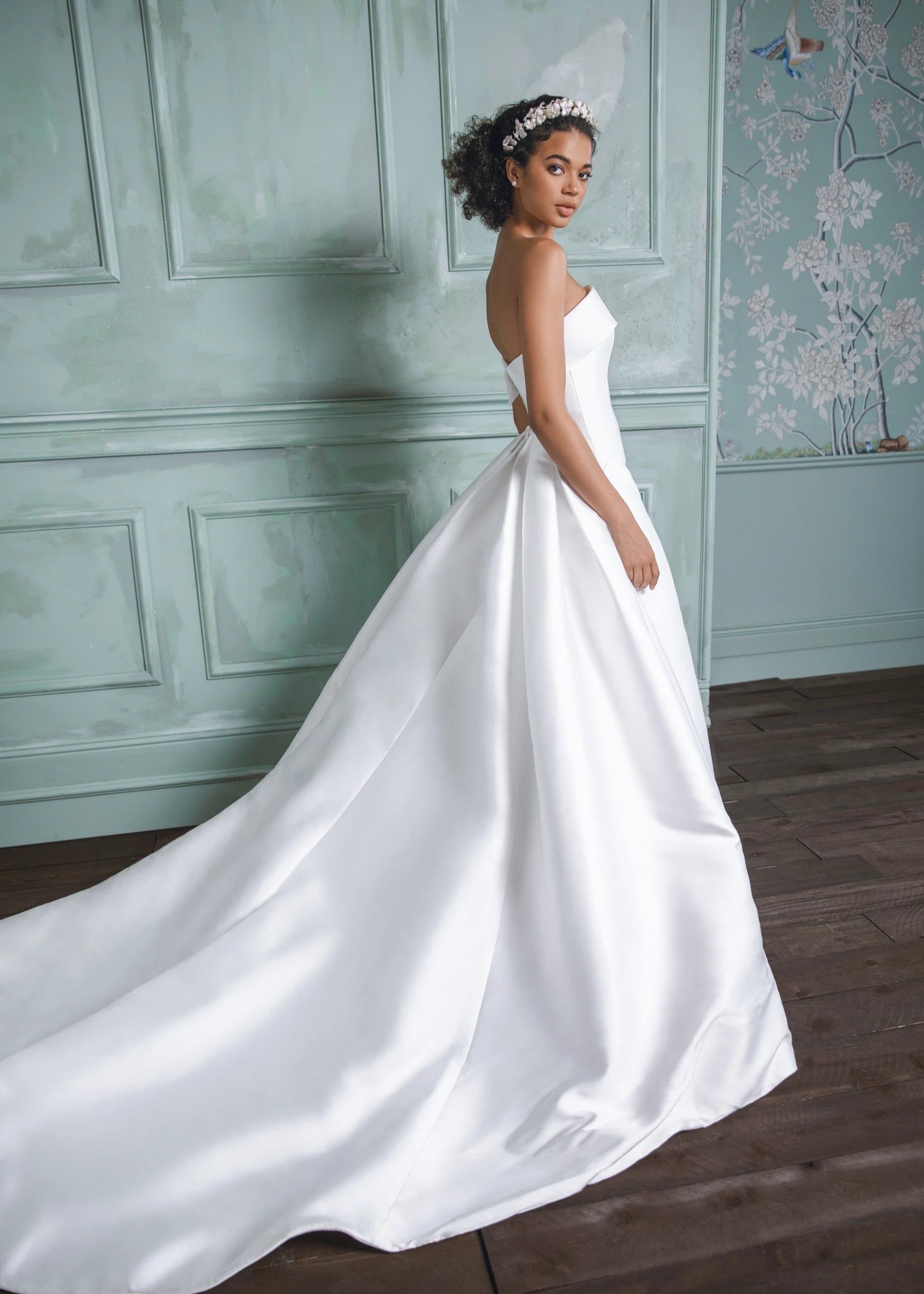 The Newport Train by Anne Barge is a pleated detachable train of Mikado Scuba, attached by a curved row of fabric covered buttons in Silk White.