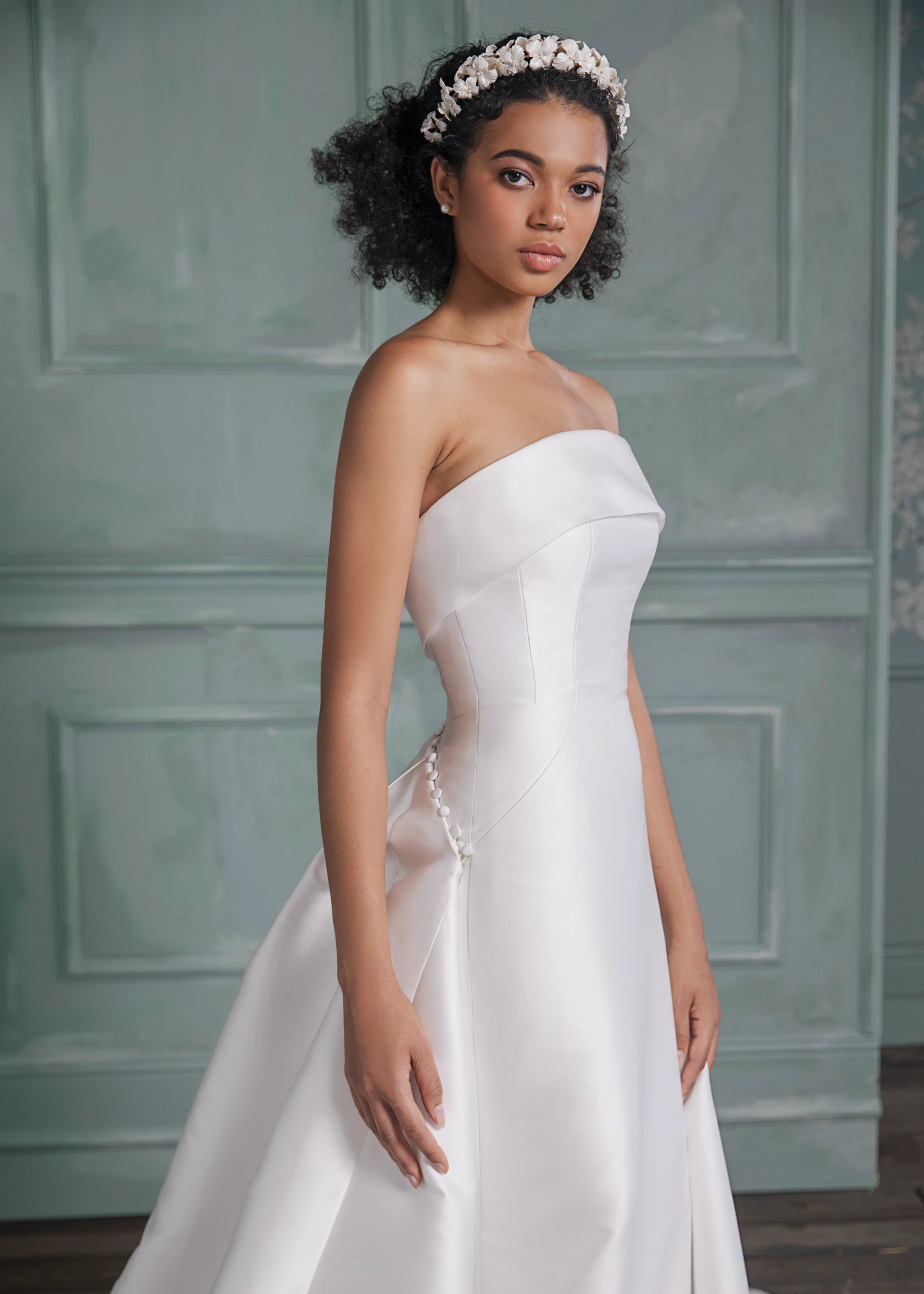 The Newport Train by Anne Barge is a pleated detachable train of Mikado Scuba, attached by a curved row of fabric covered buttons in Silk White.