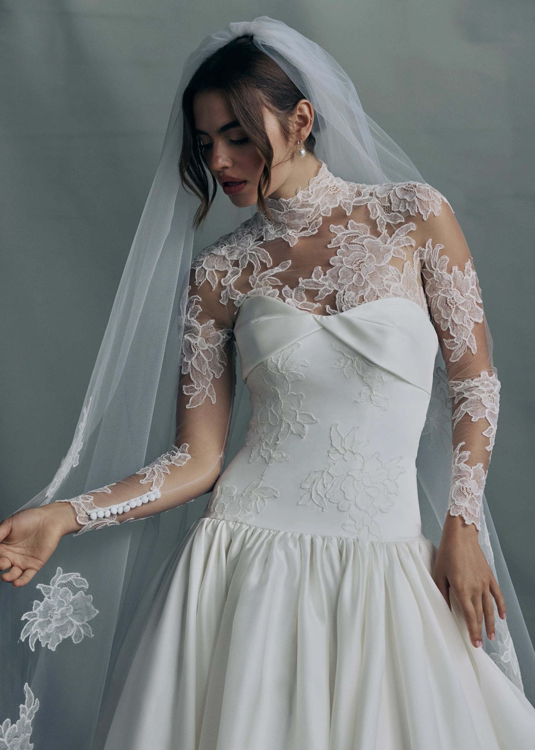 The Noblesse gown paired with the The Anouk veil, a mantilla veil with Corded Scrolling Floral Lace border in Silk White.