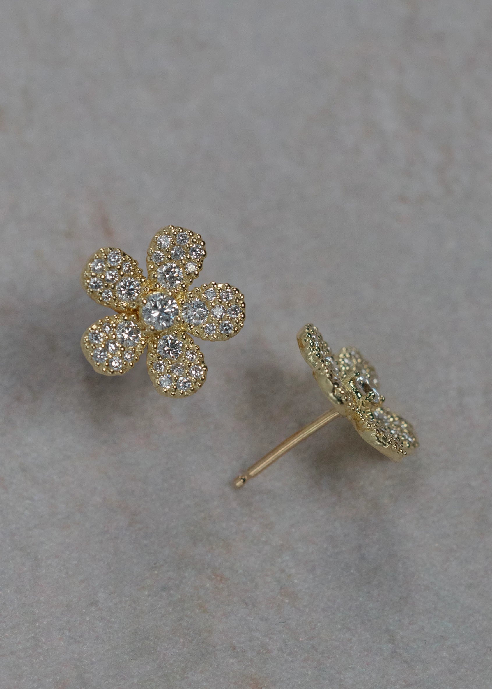 Designed by Atlanta jewelry designer Laura Pearce, delicate pave diamond daisy studs, featuring 0.95 CTTW in brilliant diamonds, and available in 18K Yellow or White Gold.