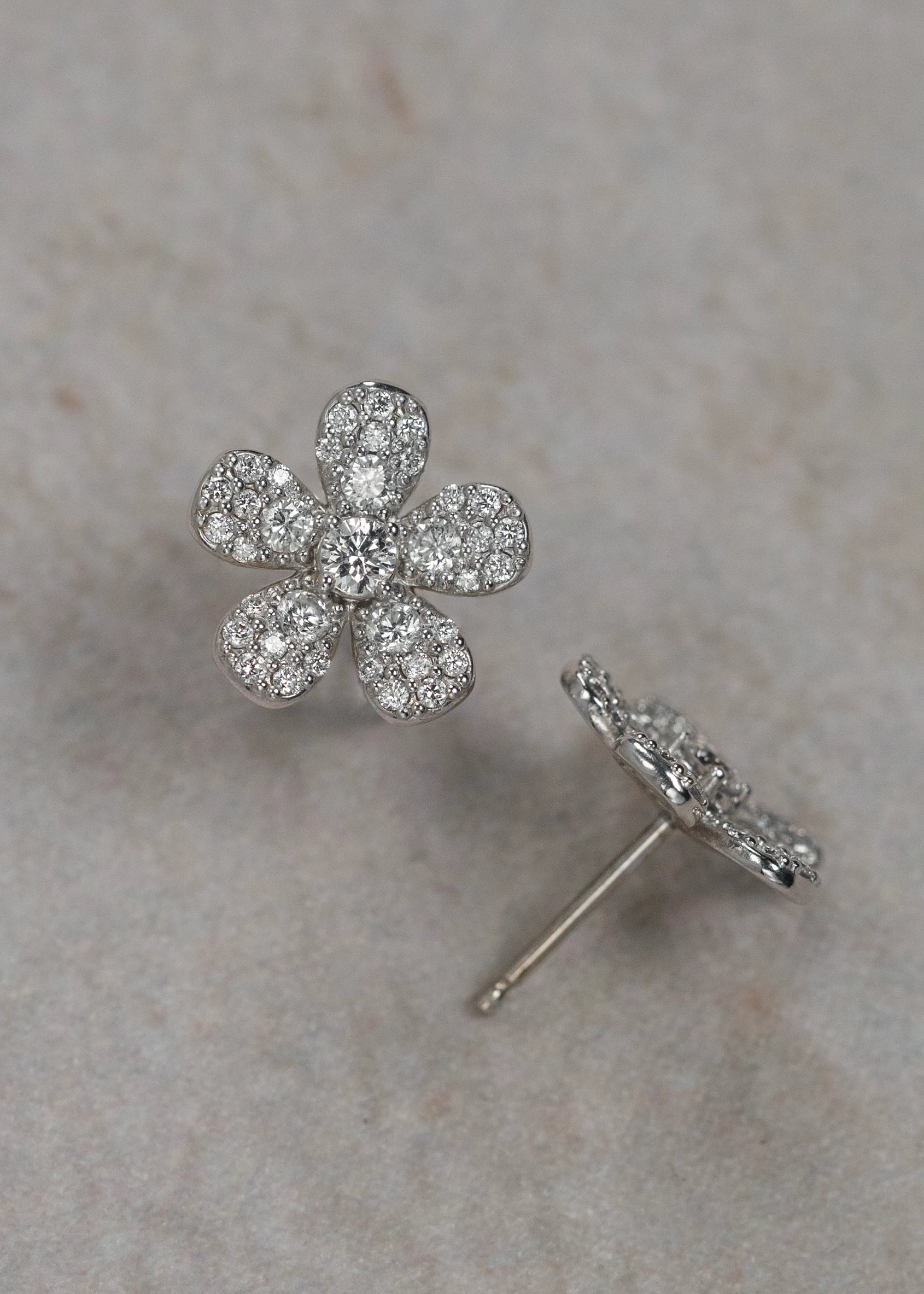 Designed by Atlanta jewelry designer Laura Pearce, delicate pave diamond daisy studs, featuring 0.95 CTTW in brilliant diamonds, and available in 18K Yellow or White Gold.