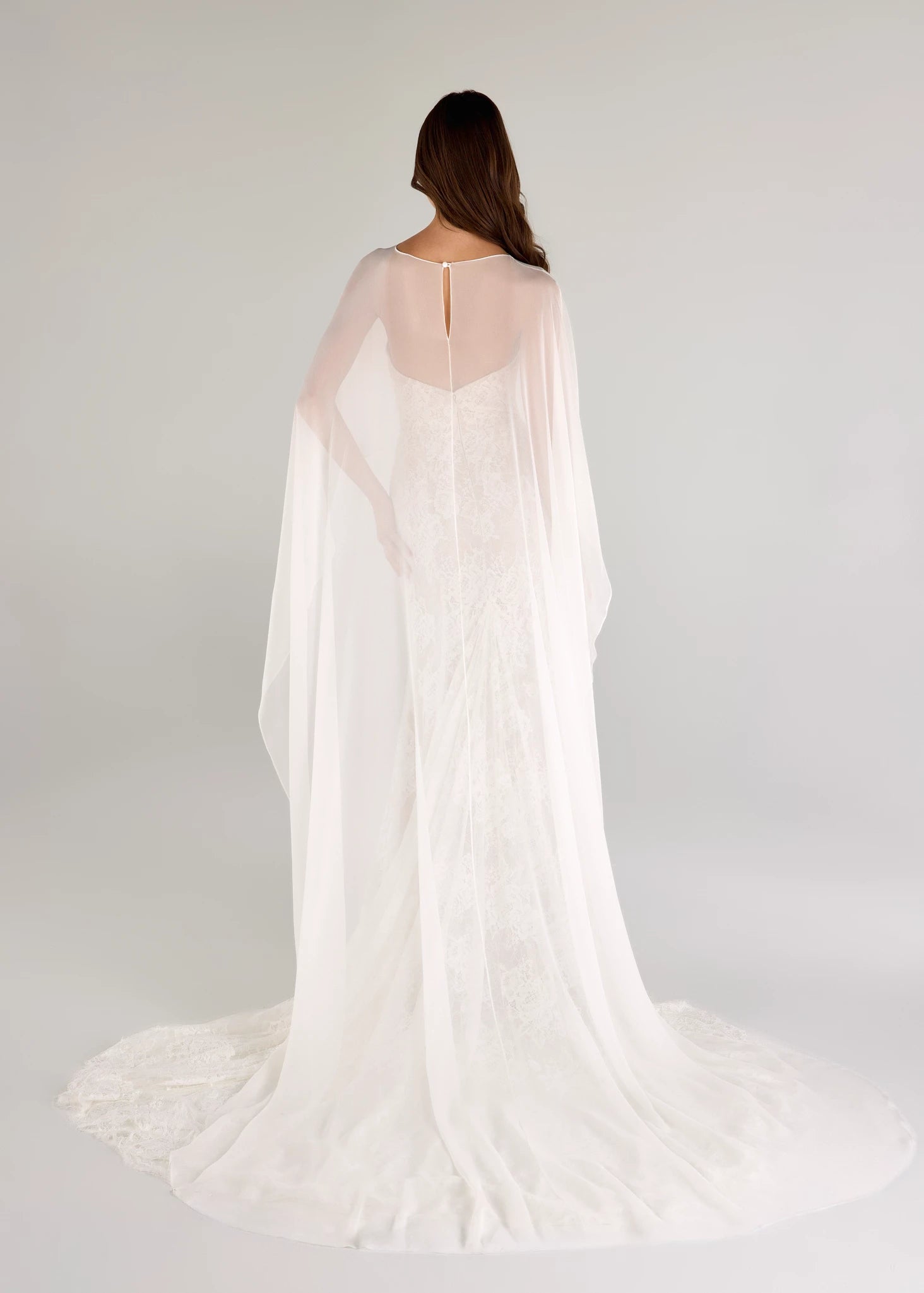 The Blue Willow Pawley Cape is a high-low Silk Chiffon cape with chapel length train in Silk White.