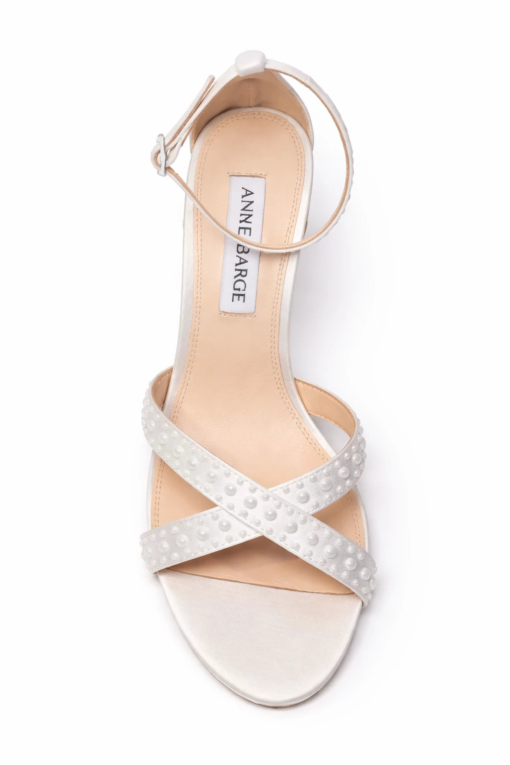 The Anne Barge Perle wedding shoe, is a round toe block heel sandal on a 90 mm heel with all over pearl detailing, set on a angled high block heel.