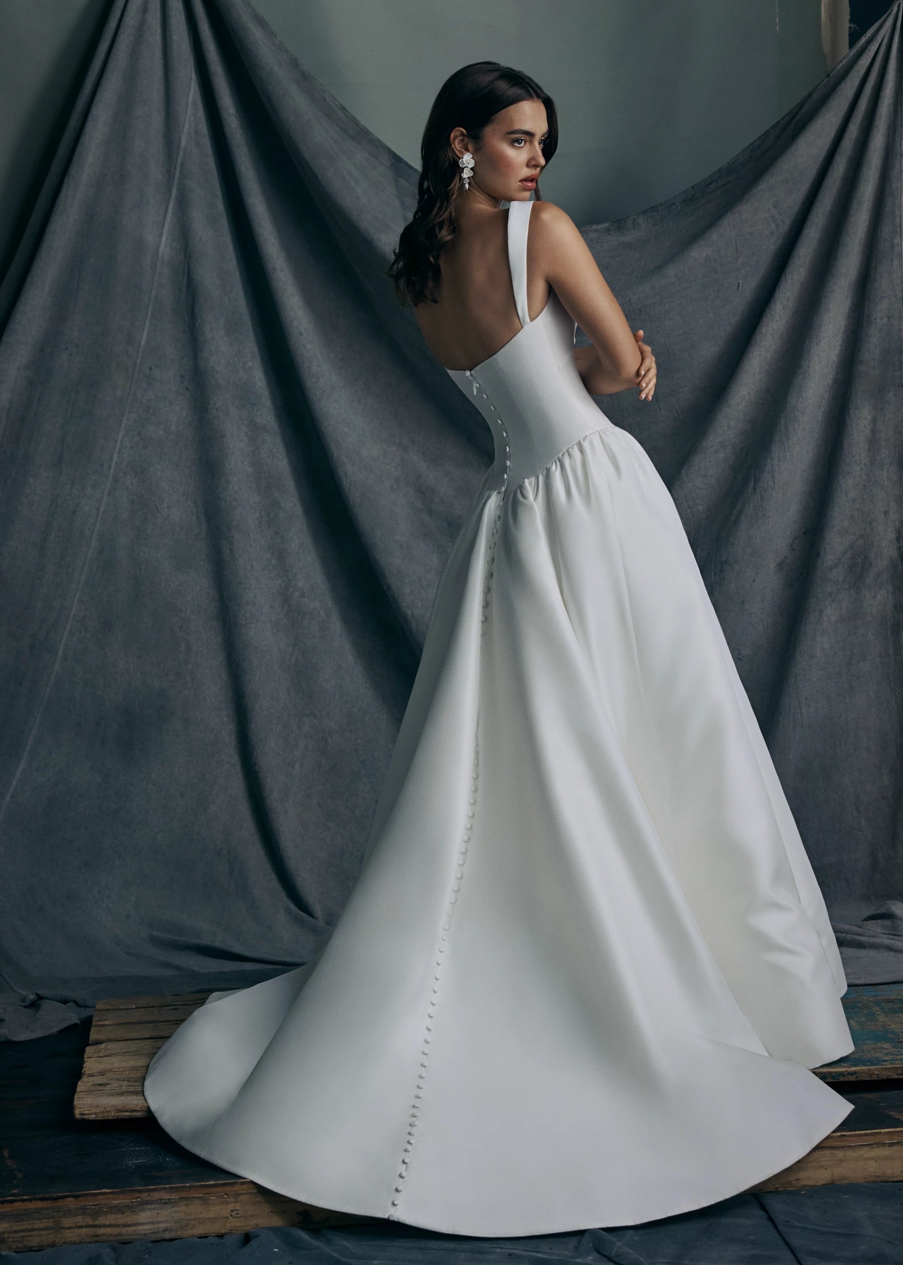 The back view of the Verite gown by Anne Barge is a sculpted sweetheart ballgown in Kalika with contour straps, featuring a ziggurat dropped waist and buttons to the hem.