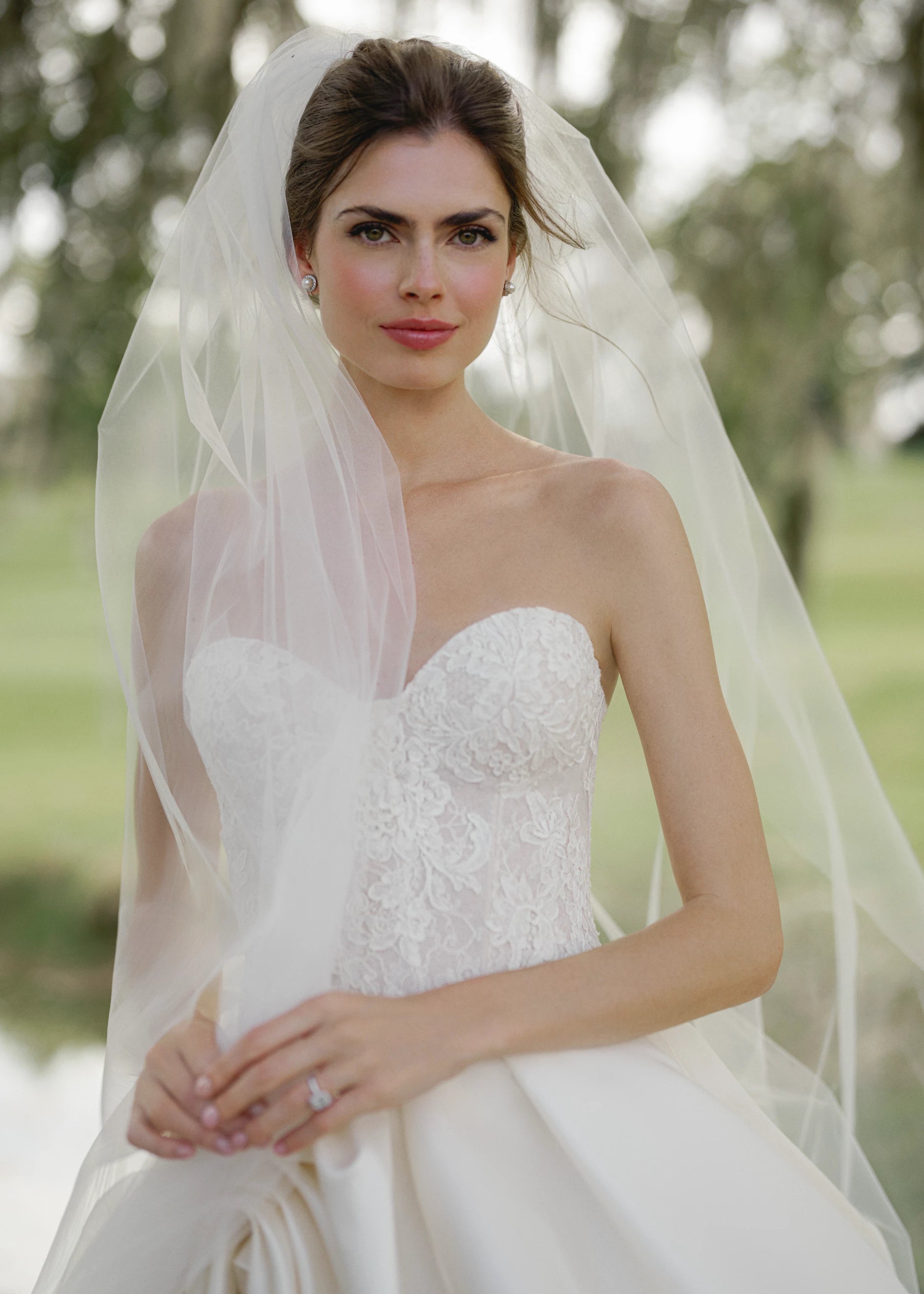 The Wentworth gown is a strapless drop waist corset bodice of French Alençon and Chantilly laces with an Italian Kalika ballgown skirt featuring sculptural origami-style pick-ups and asymmetric waterfall draping.